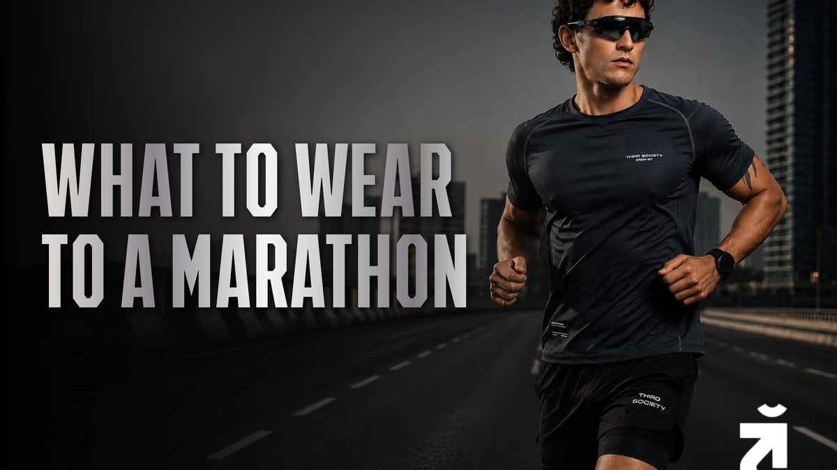 Man wearing the Third Society Run Base Performance T-Shirt Black and Hybrid Liner Shorts Black while running on a city road