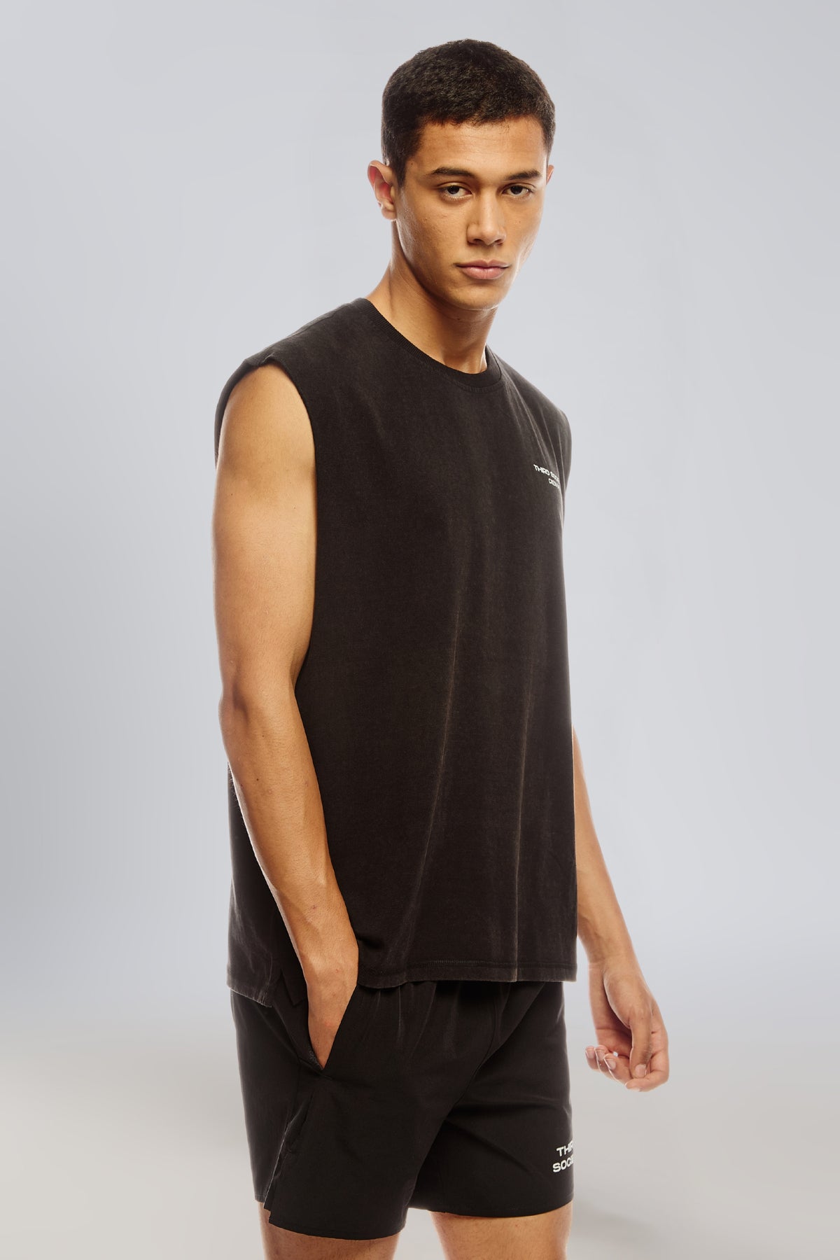 Side view of black sleeveless tank top showing the relaxed oversized fit