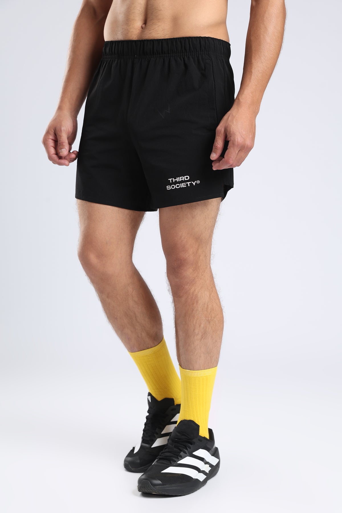 Model wearing black Hybrid 5-Inch Running Shorts with an elastic waistband