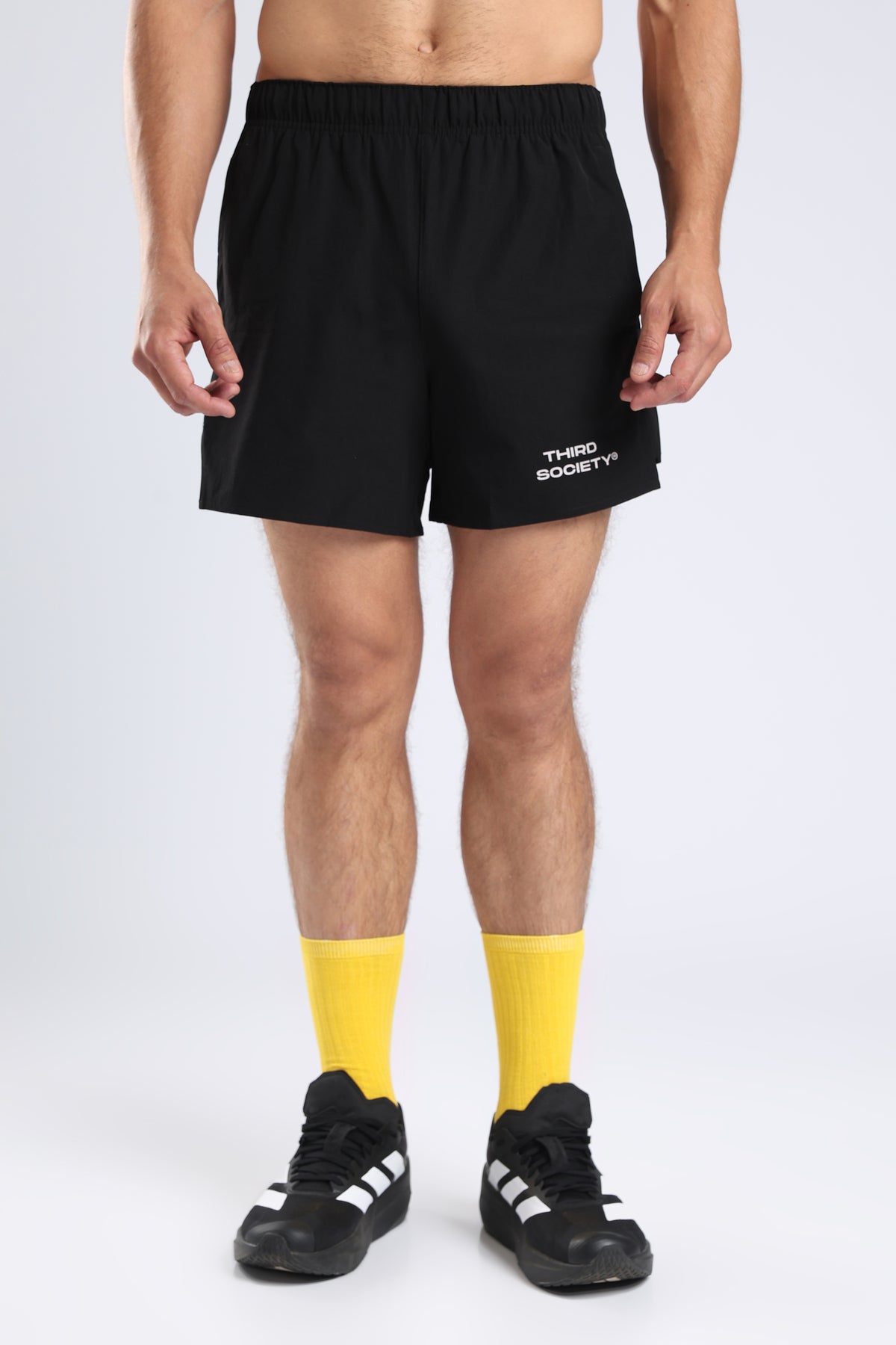 Front view of black Hybrid 5-Inch Running Shorts with the Third Society logo