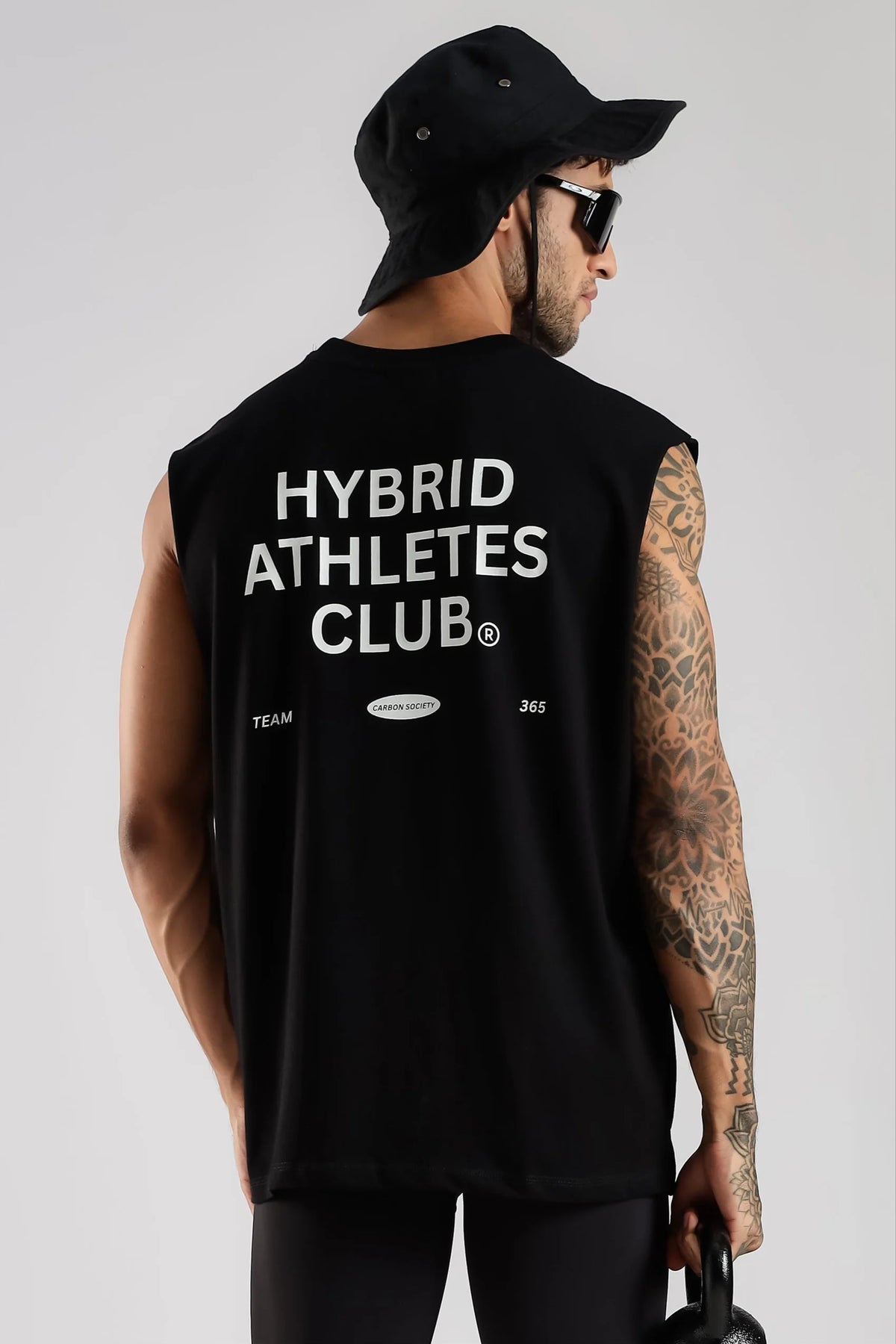 Black sleeveless tank top showing Hybrid Athletes Club back graphic and relaxed fit
