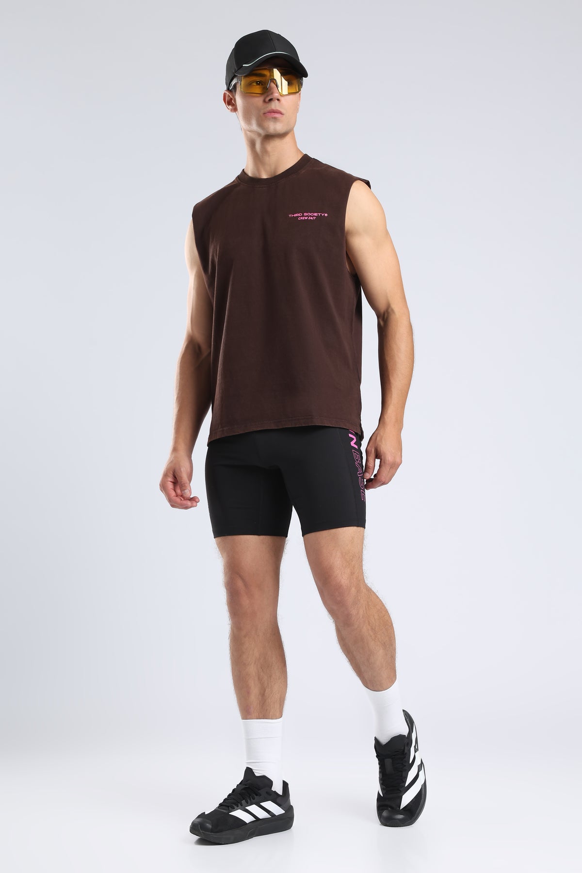 Full view of the Burnt Umber Hybrid Athletes tank styled with black shorts and trainers