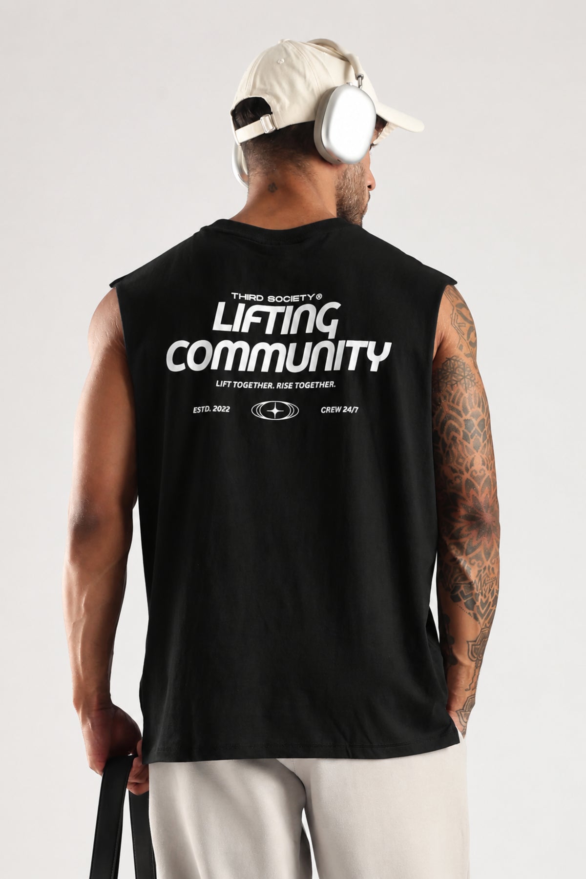 Model wearing the black Lifting Community tank top showing the back graphic