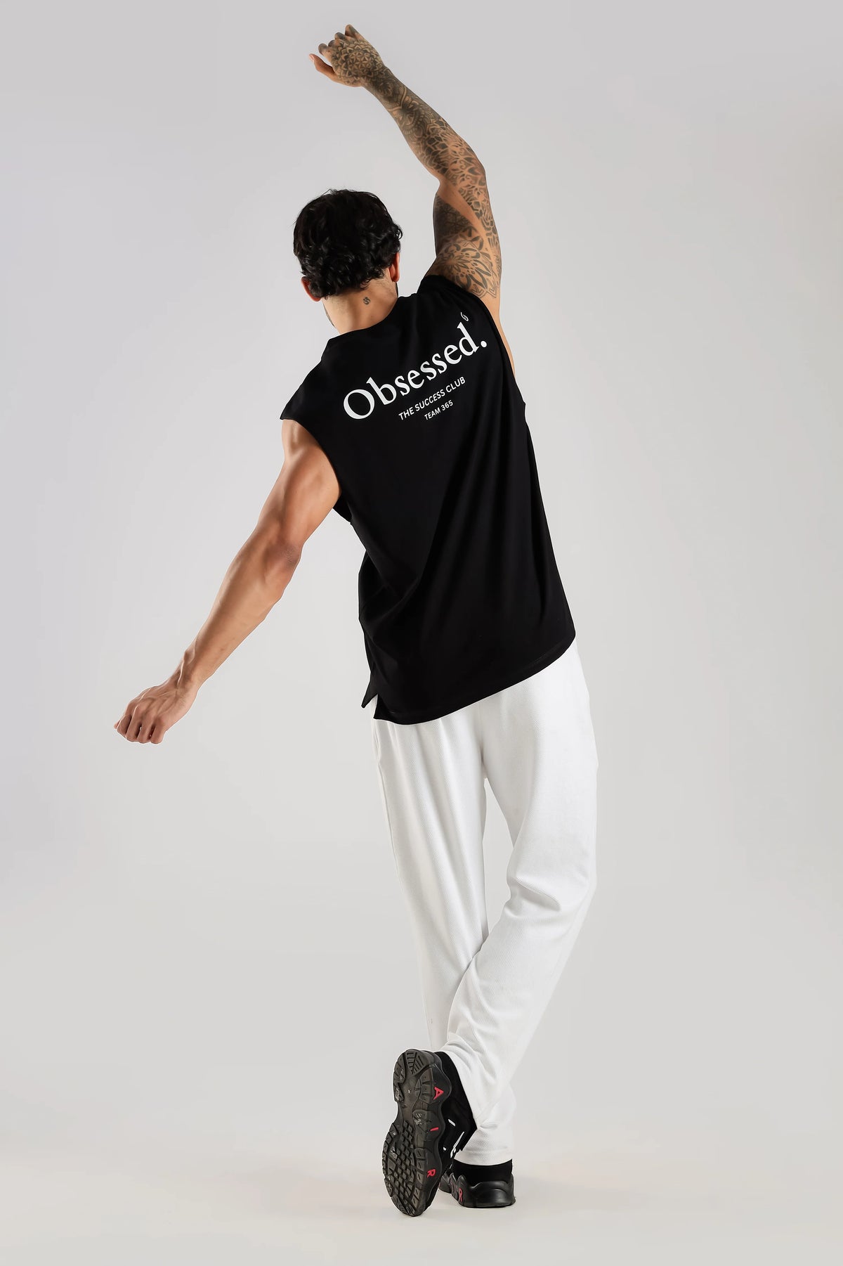Black oversized tank top showing the relaxed fit during movement