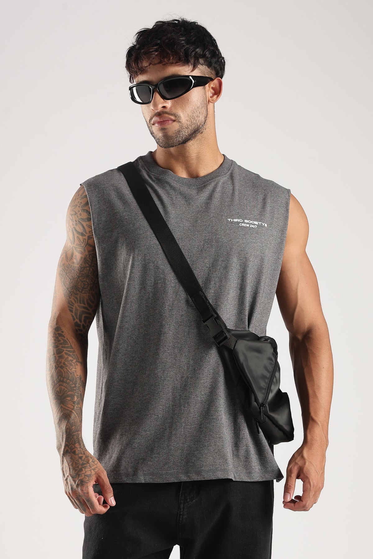 Model wearing the Grey Marl Obsessed Tank with sunglasses, black trousers and a crossbody bag