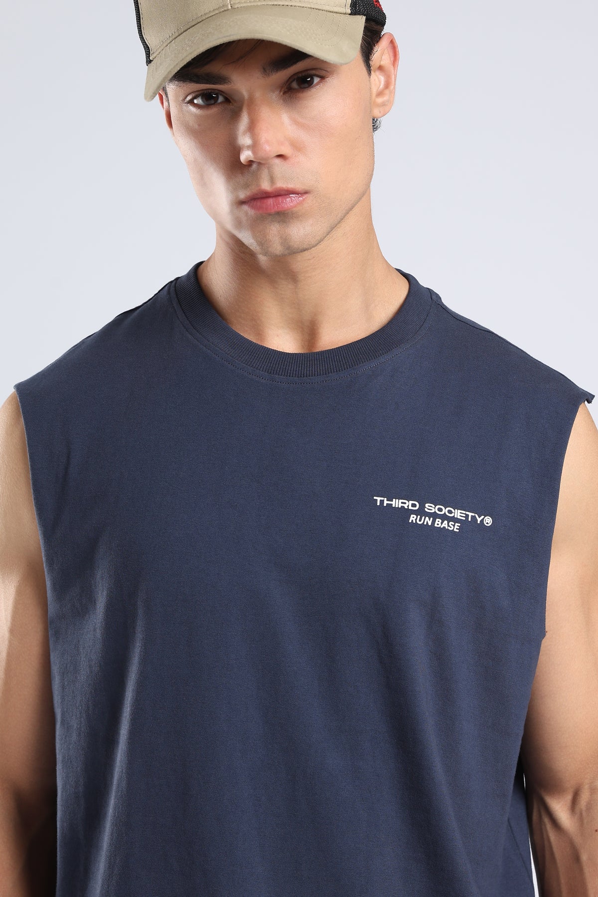 Model wearing the Iron Blue sleeveless tank with a relaxed fit