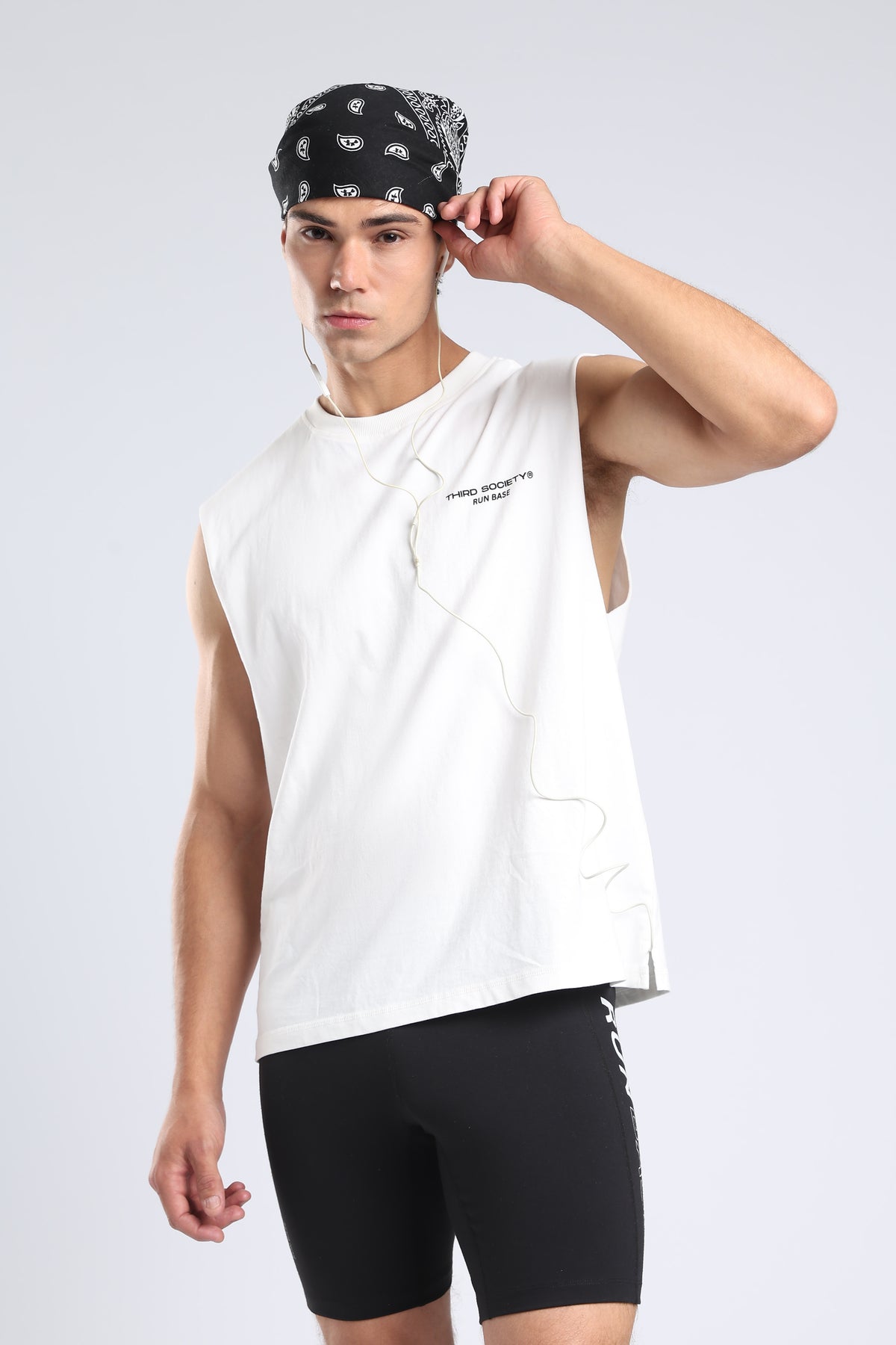 Model wearing the white Runners Without Permission tank with a black bandana
