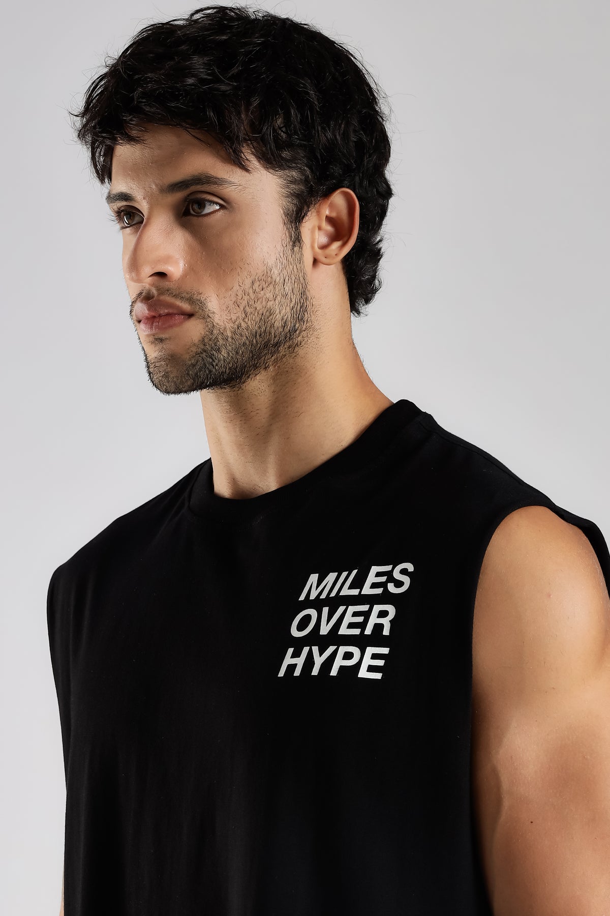 Black running tank top with Miles Over Hype chest graphic
