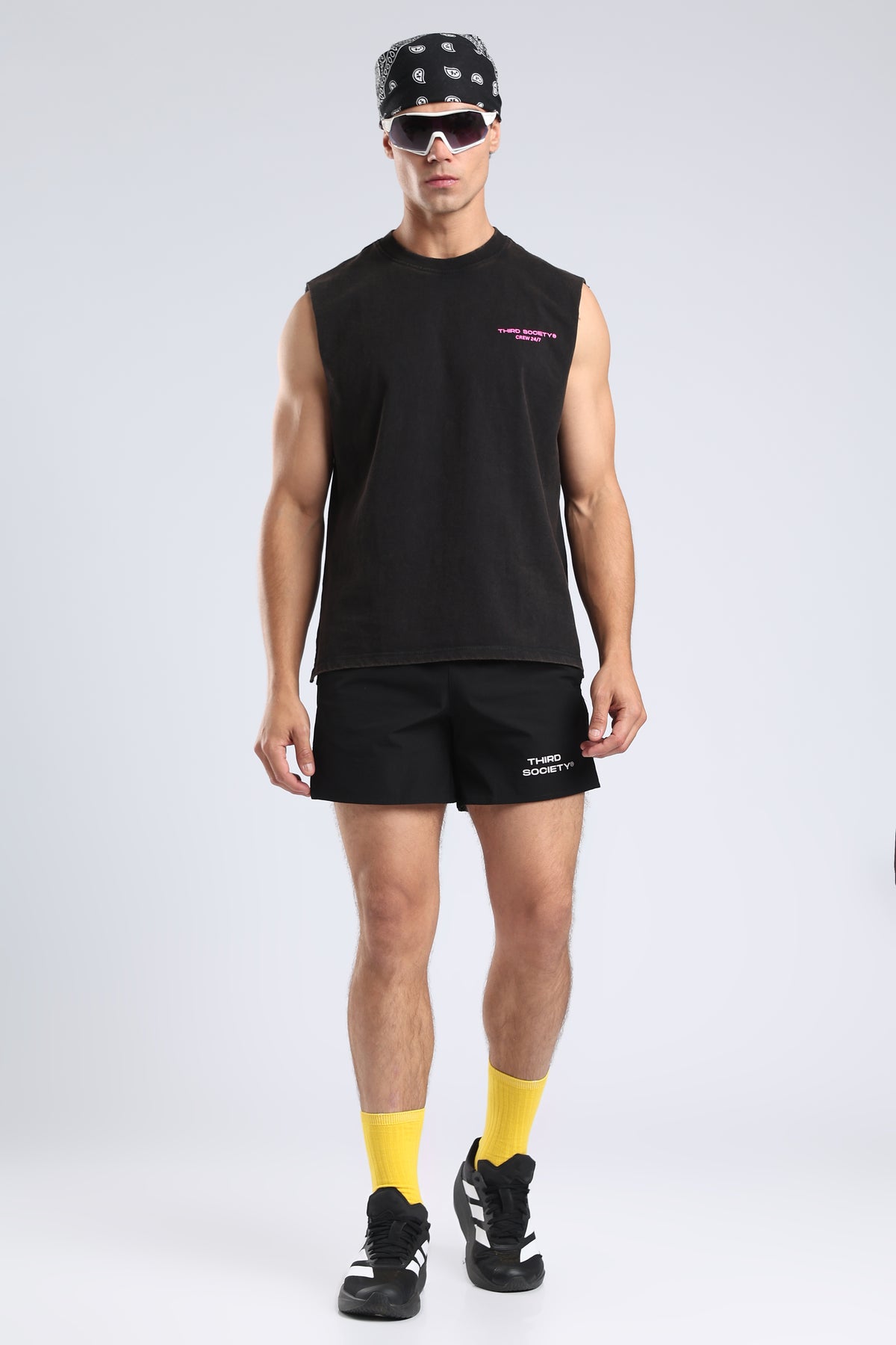 Model wearing the Carbon Wash tank with black shorts and yellow socks