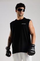 Model wearing the black Combat Club tank top from the front with Crew 24/7 chest branding