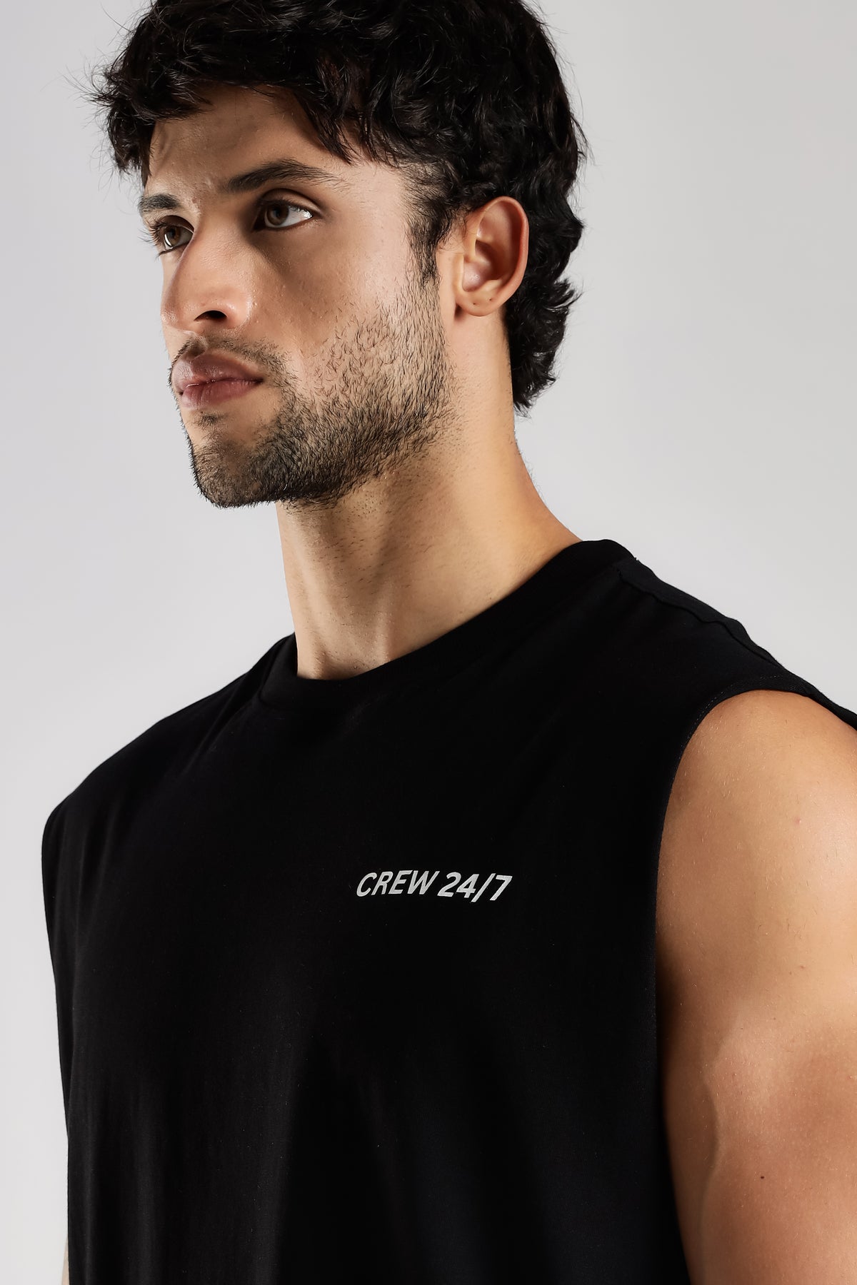 Side view of the black Combat Club tank top showing the oversized fit