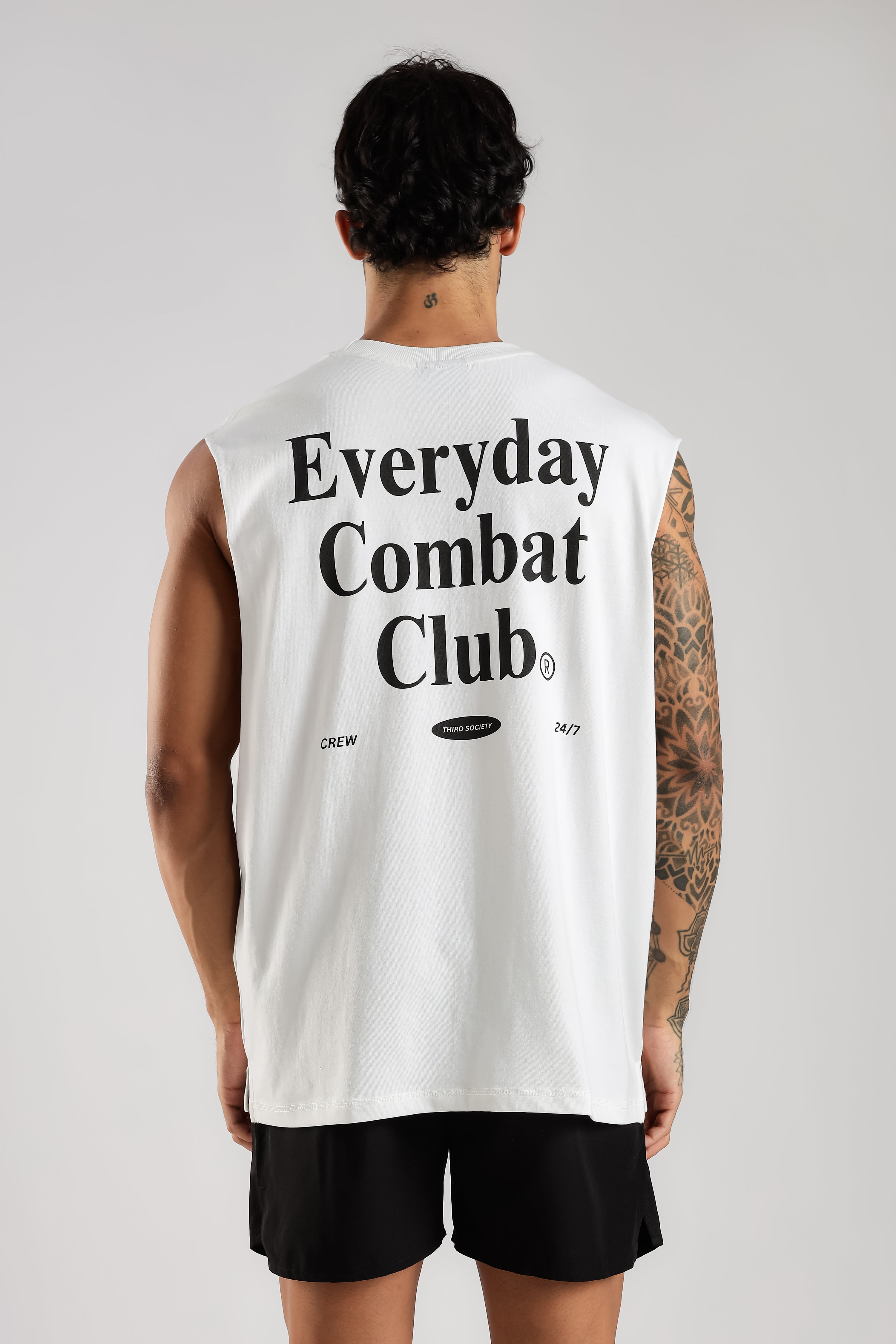 Model showing the large black Combat Club print on the back of the white tank