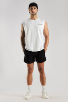 Model wearing the white Combat Club Tank with a small chest logo and black shorts