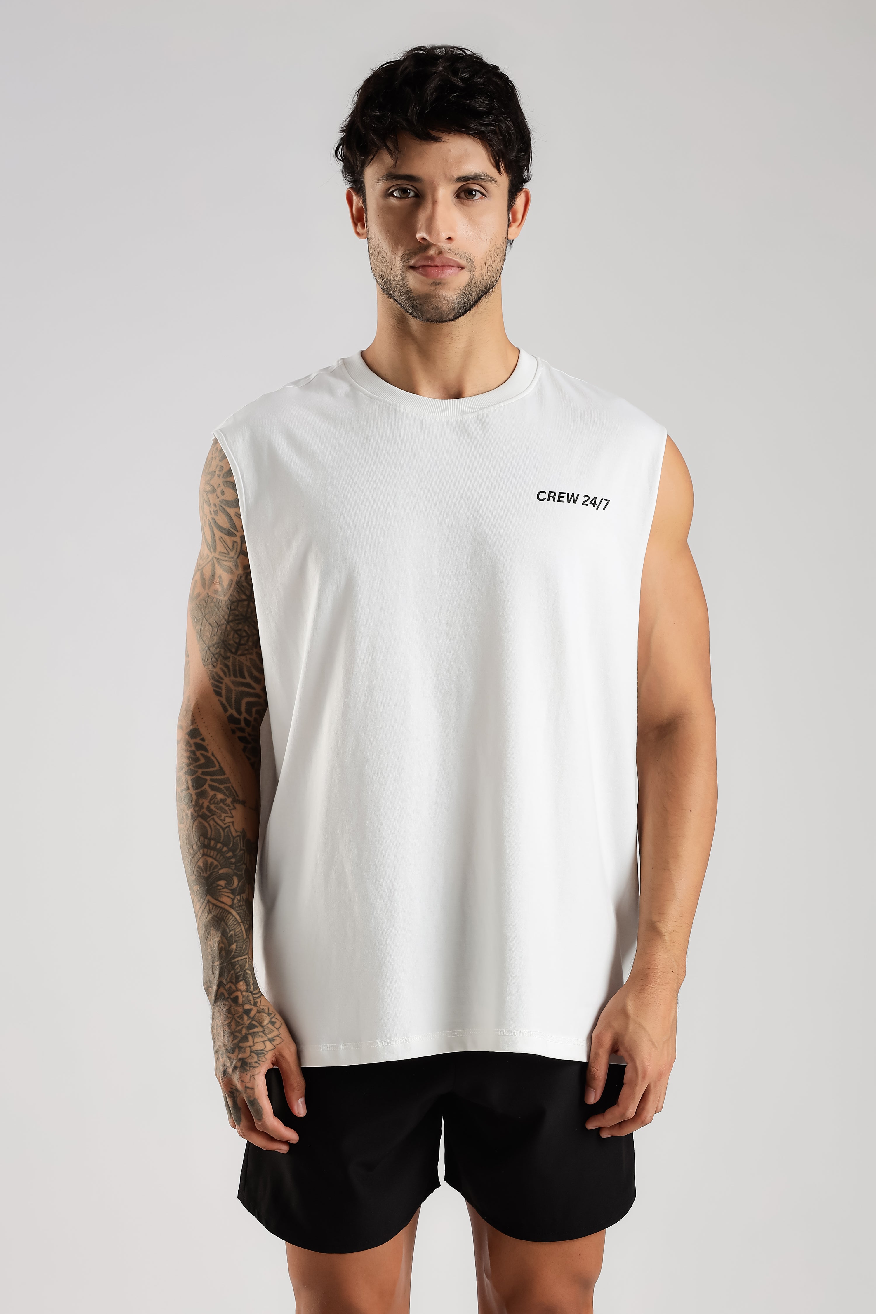 Front view of the white Combat Club Tank with a minimal black chest logo