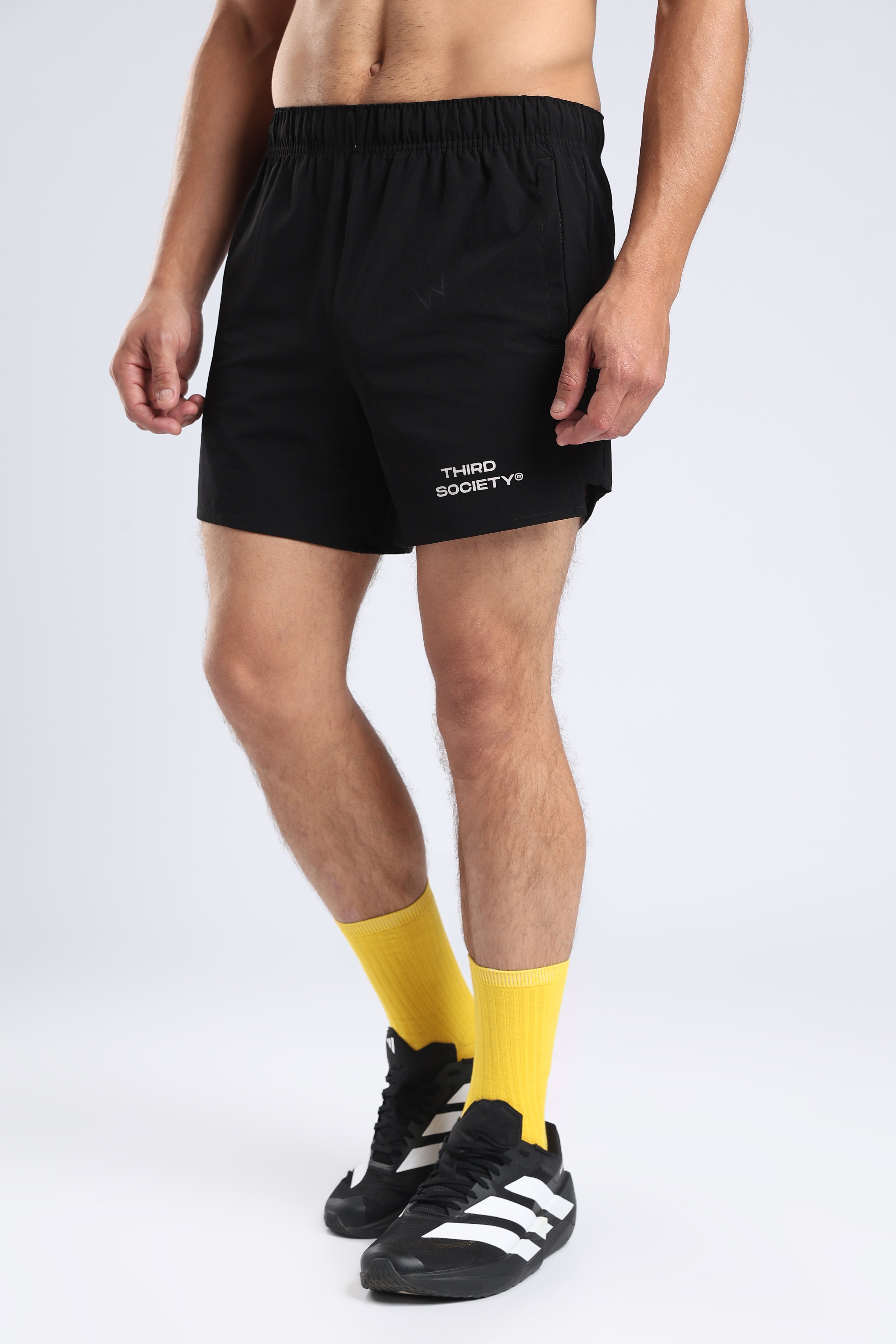 Model wearing black Hybrid 5-Inch Running Shorts with an elastic waistband