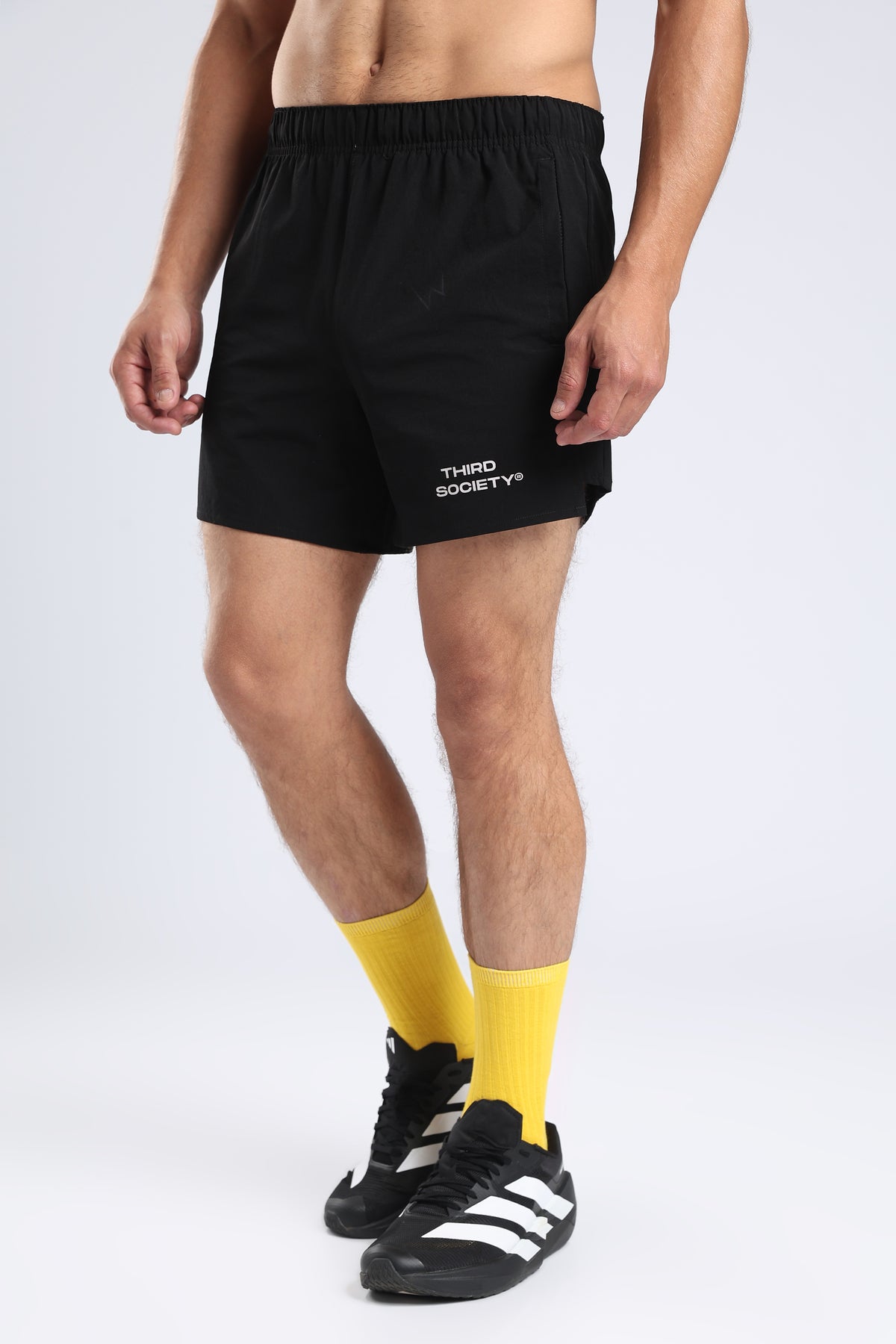 Model wearing black Hybrid 5-Inch Running Shorts with an elastic waistband