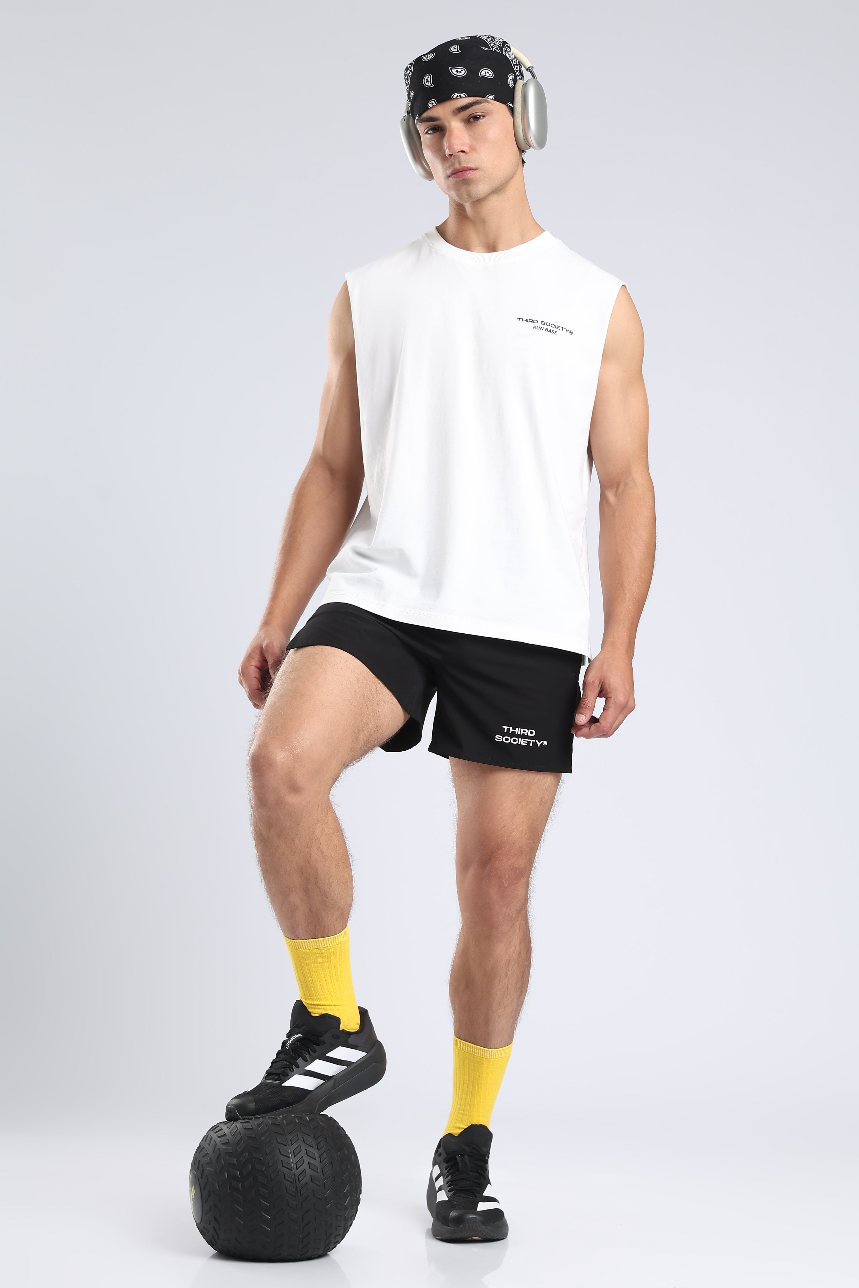 Model wearing black Hybrid 5-Inch Running Shorts with a white oversized top during training