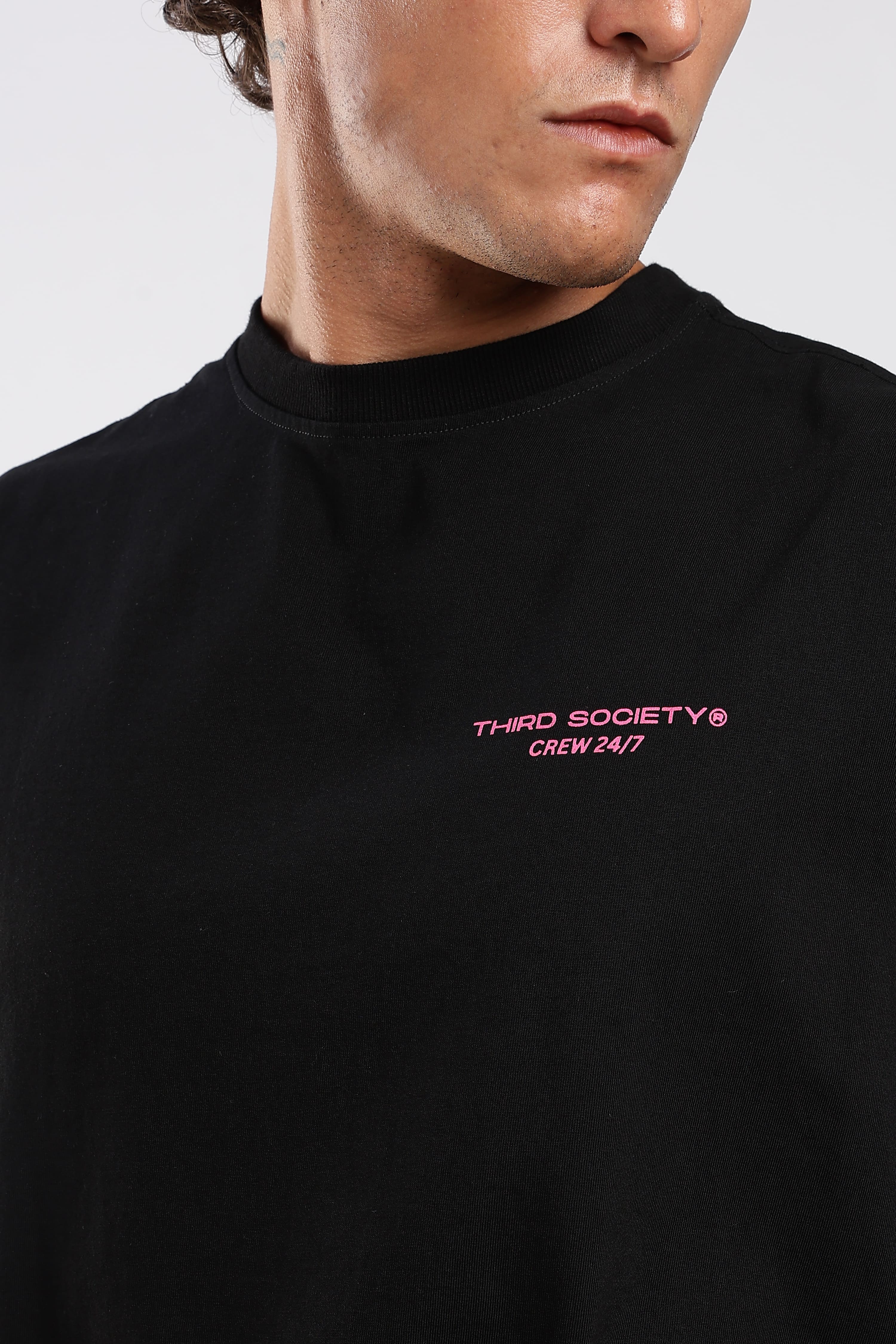 Close-up of the Third Society Crew 24/7 chest graphic on the black tank top