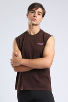 Model wearing the Burnt Umber sleeveless tank with pink chest branding