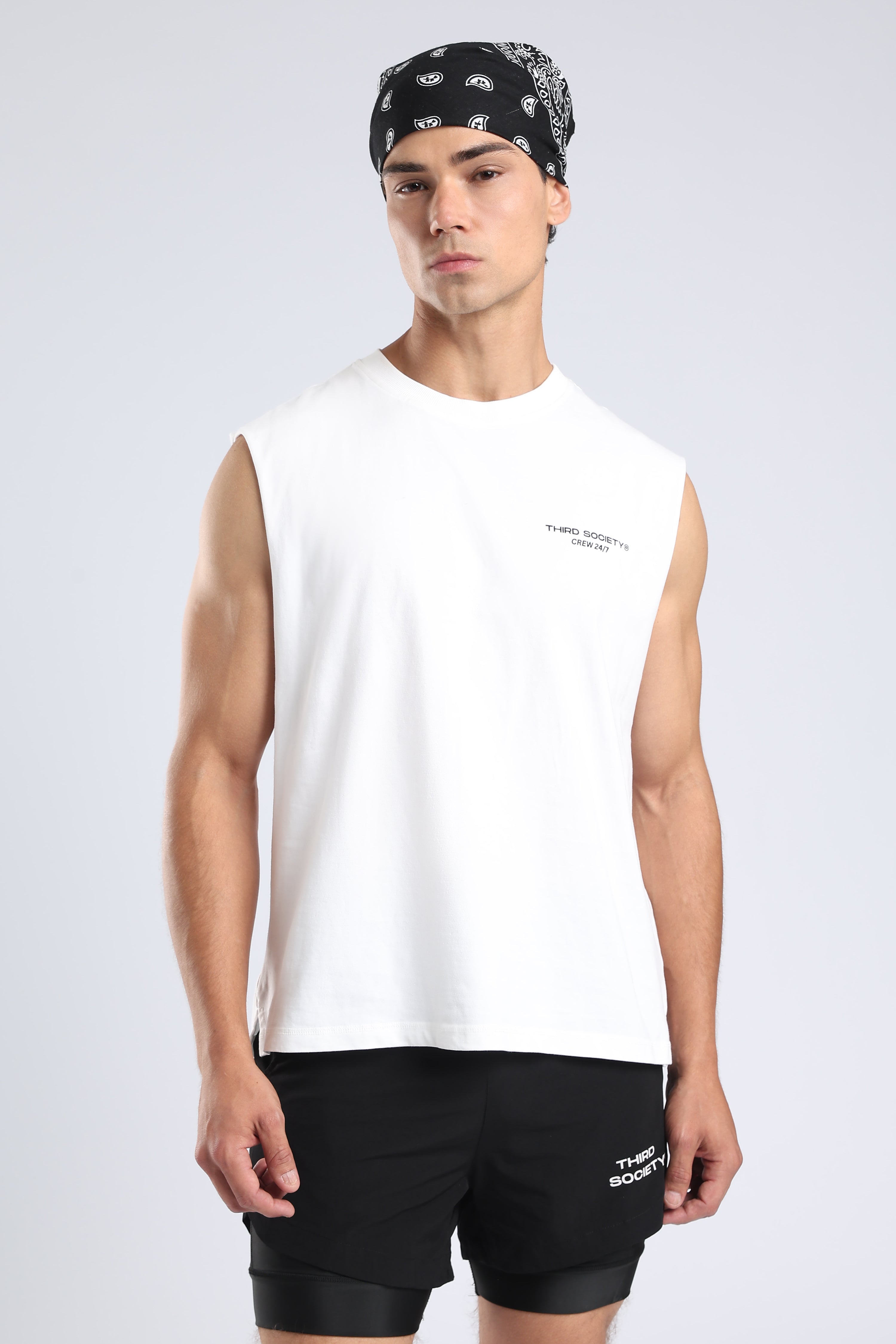 Front view of the White Hybrid Athletes tank showing its small chest logo