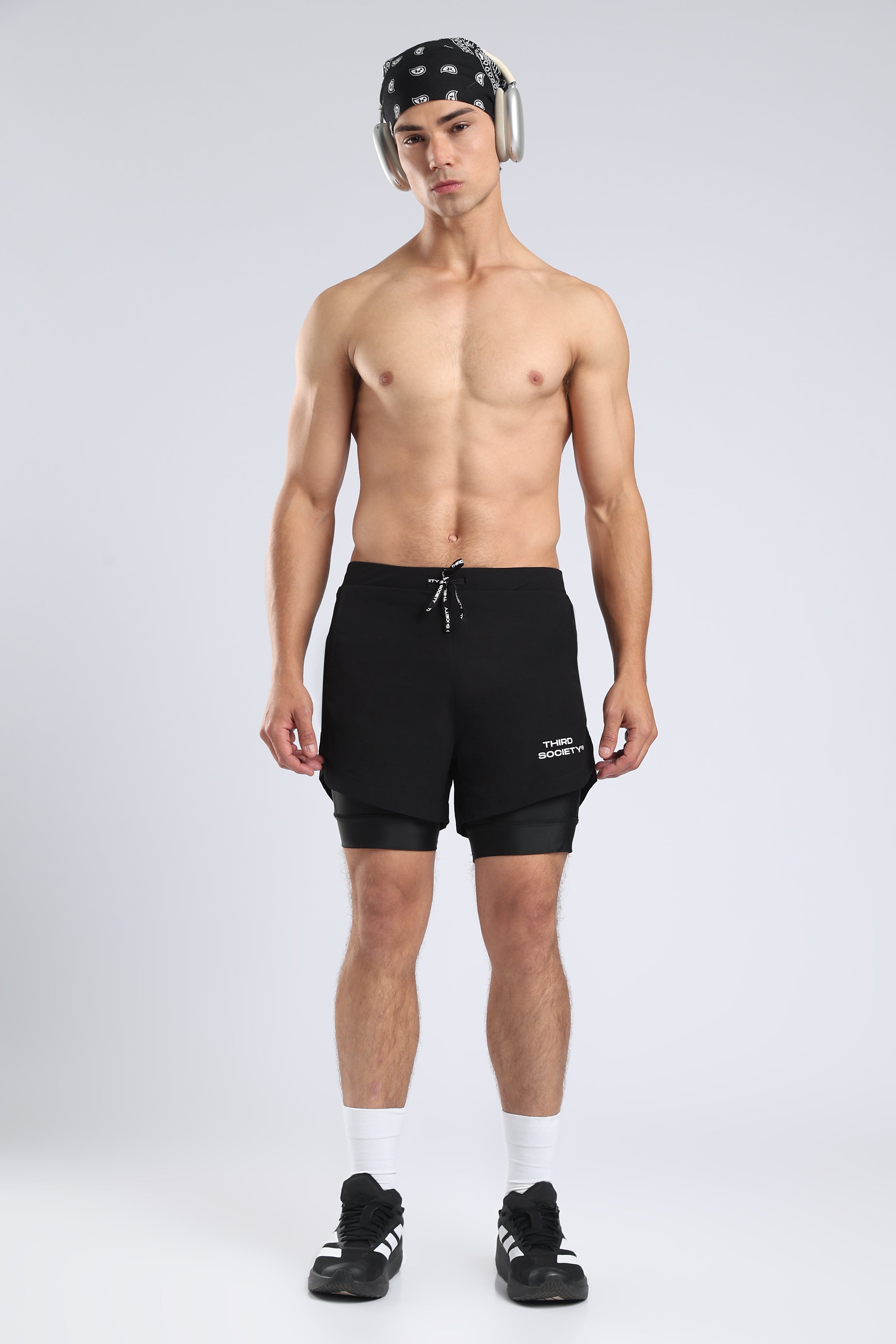Model wearing black Hybrid Liner Shorts with an integrated inner liner