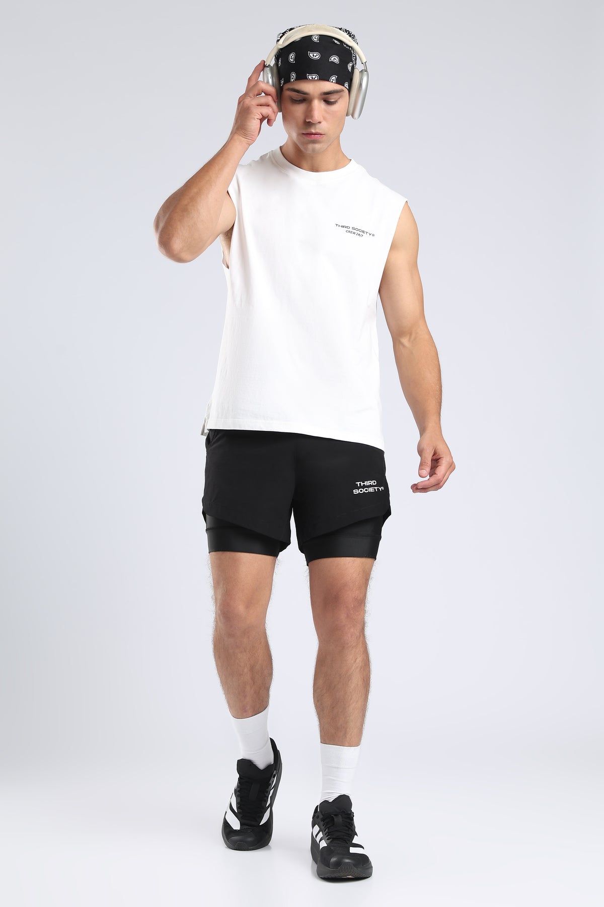 Model wearing black hybrid liner shorts with a white sleeveless training top
