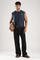 Iron Blue oversized tank styled with black trousers and a casual crossbody bag
