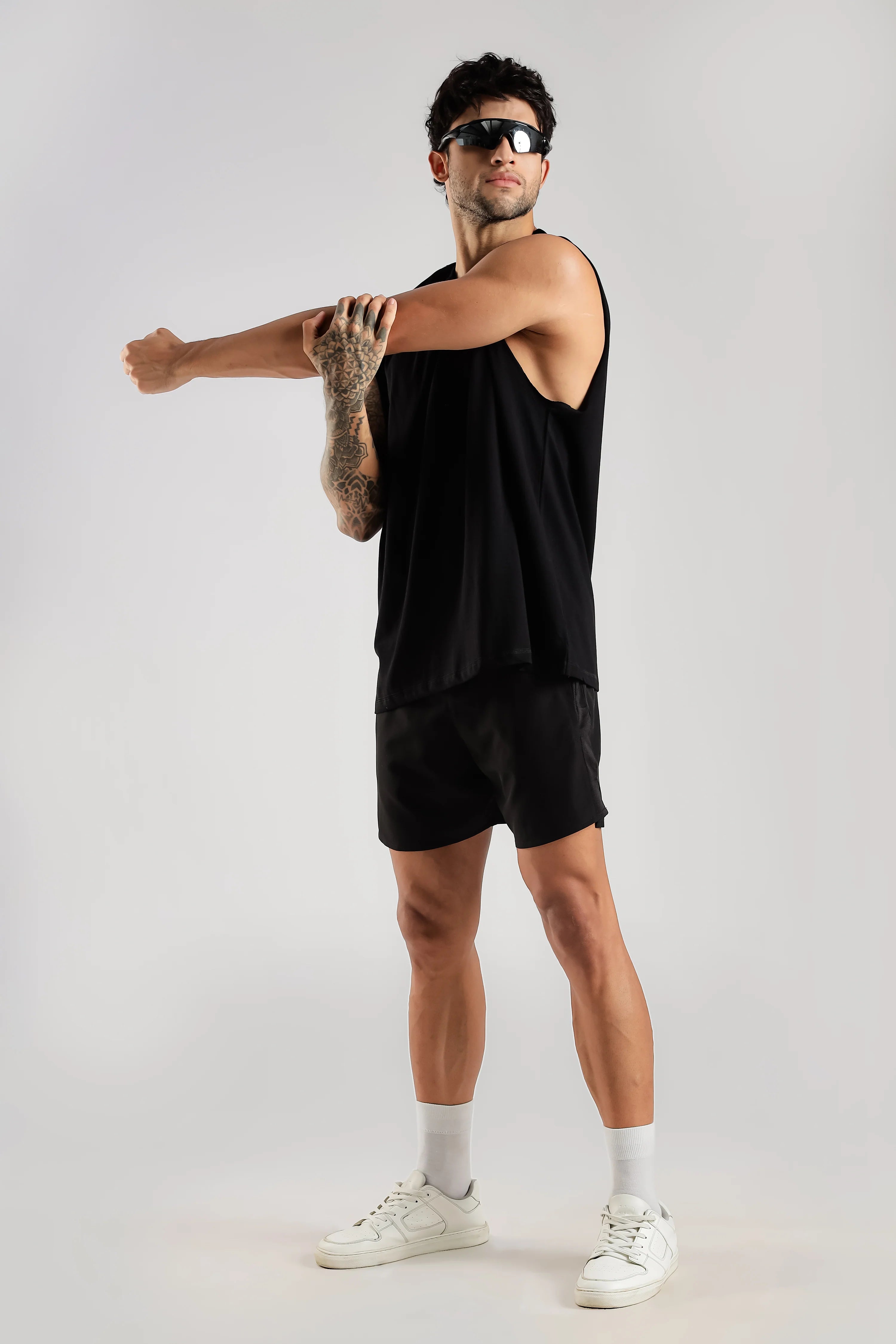 Side view of black sleeveless tank top showing the oversized fit