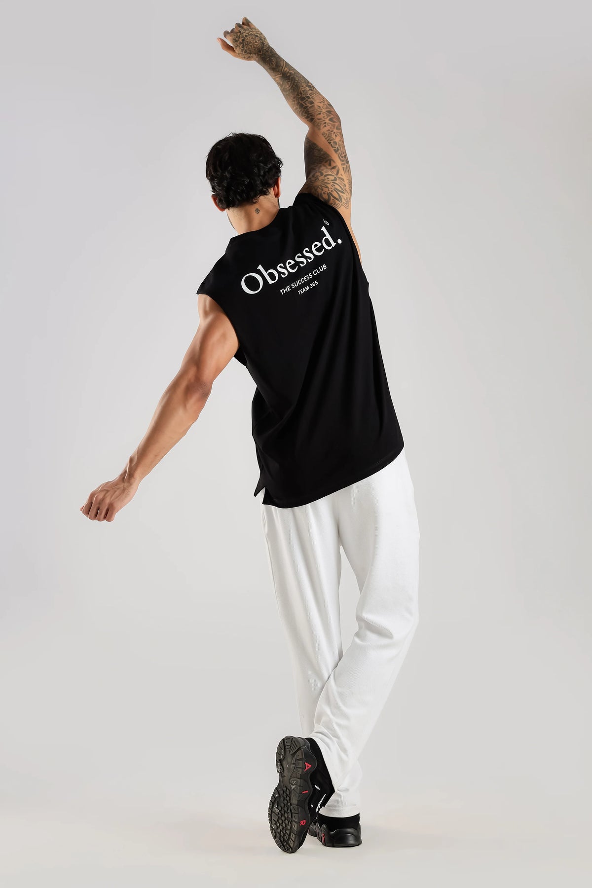 Black oversized tank top showing the relaxed fit during movement