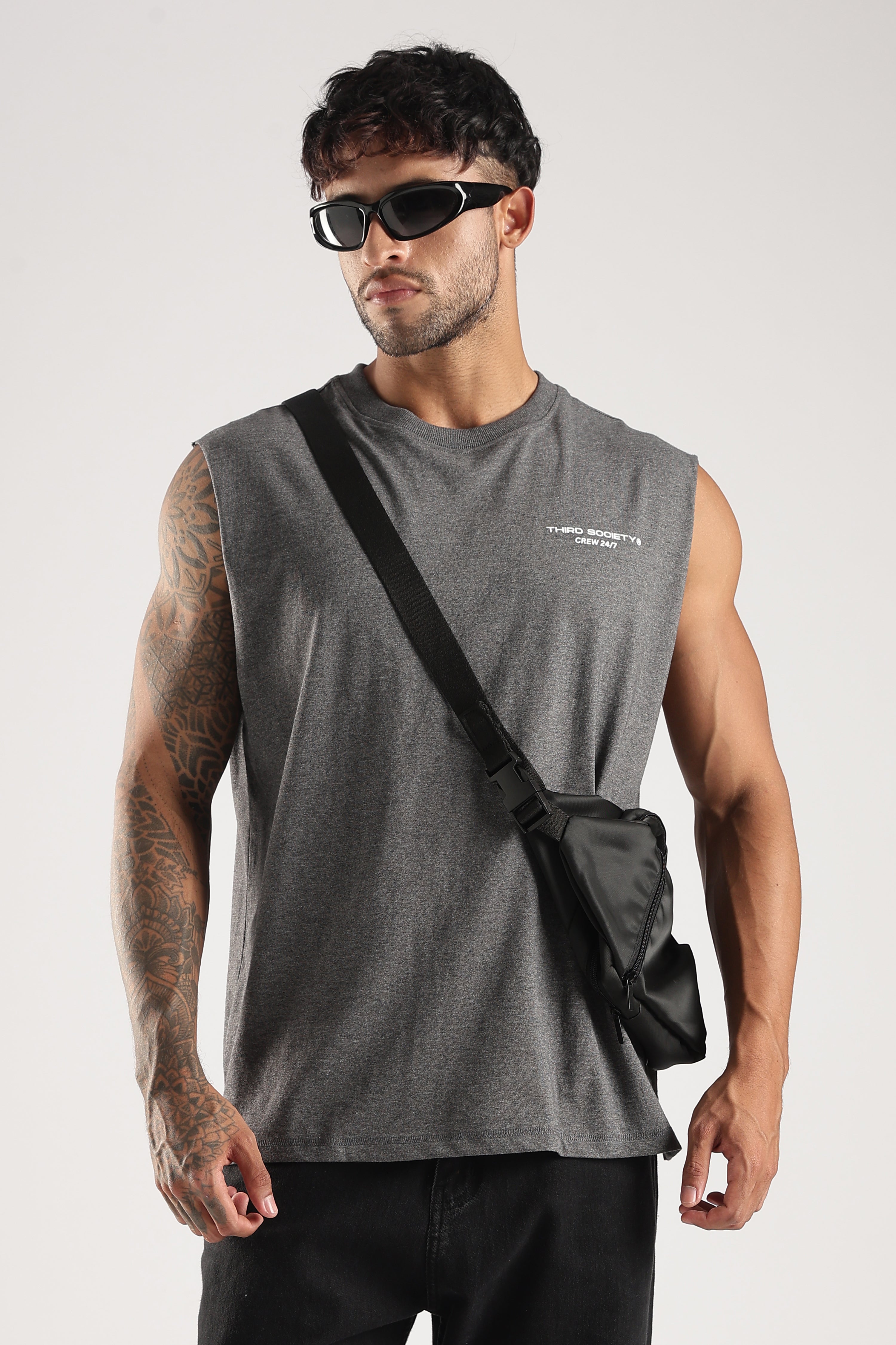 Model wearing the Grey Marl Obsessed Tank with sunglasses, black trousers and a crossbody bag