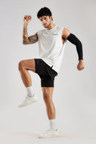 Model wearing the white Push Pull Tank during an active movement pose