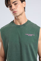 Close-up of the pink Run Base chest logo on the Forest Moss tank
