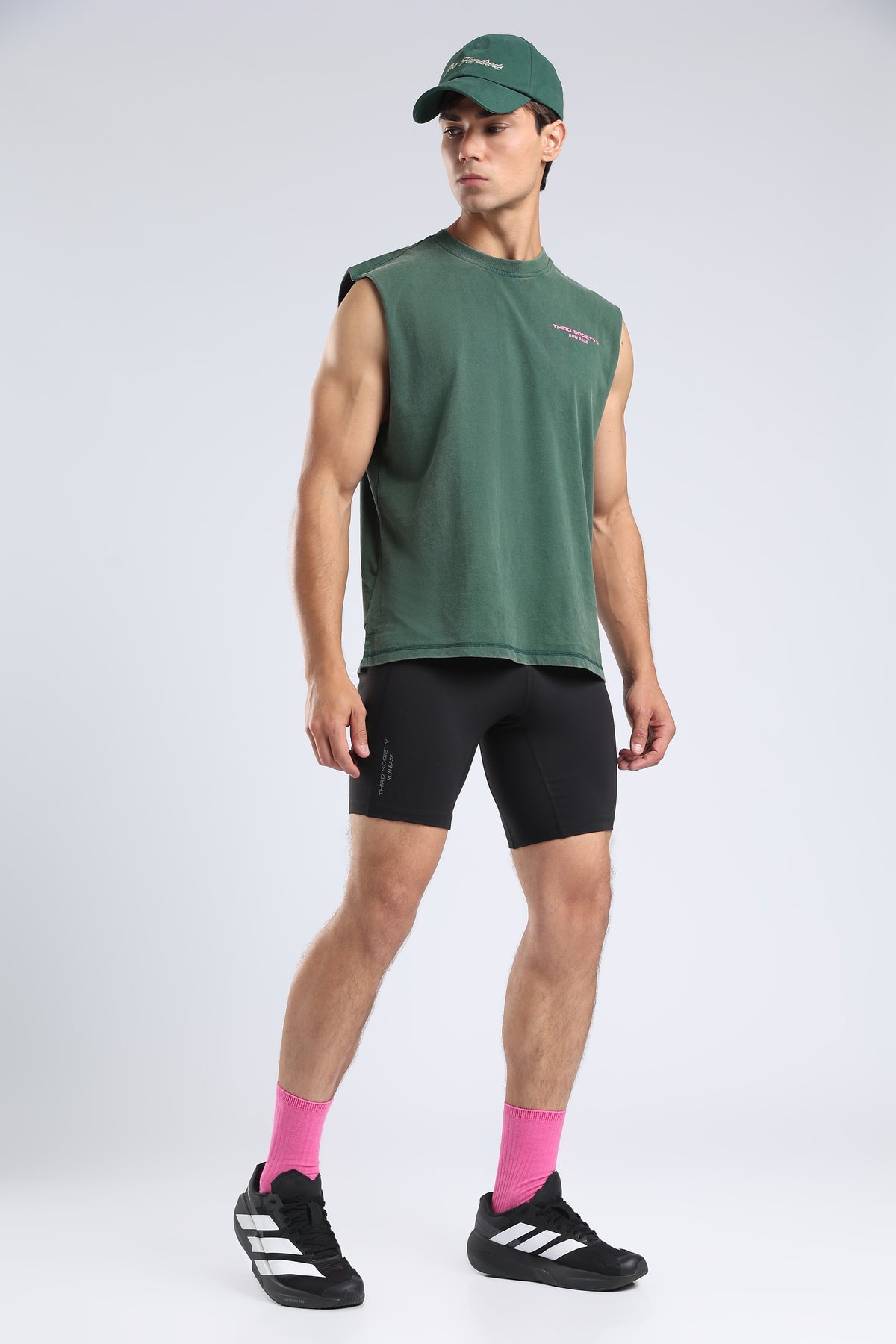 Model wearing the Forest Moss Runners Without Permission tank with black compression shorts
