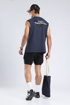Model wearing the Iron Blue tank with the Runners Without Permission back graphic and a tote bag