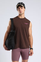 Model wearing the Brown sleeveless tank with a chest logo and casual athletic styling