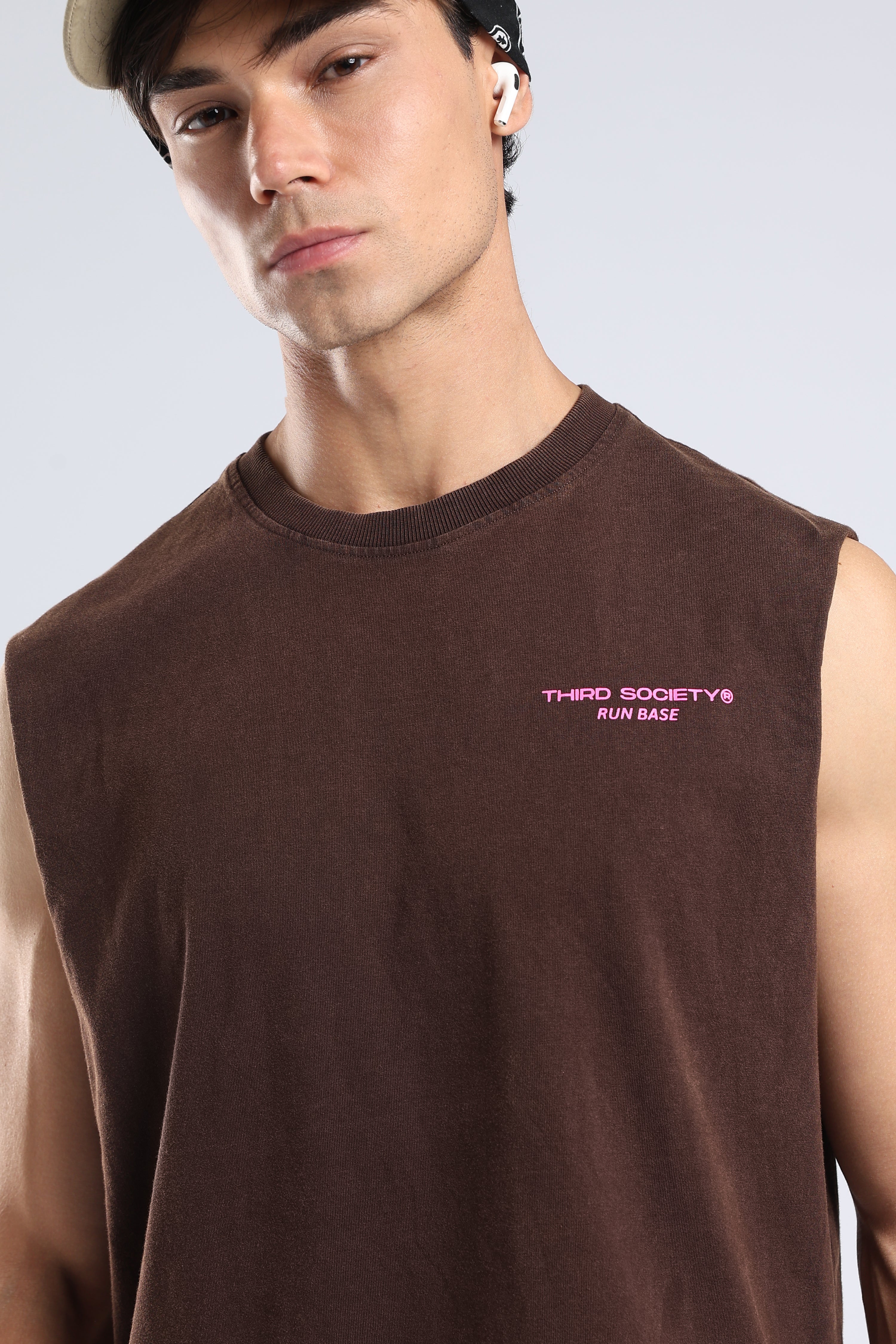 Model wearing the Brown oversized tank with a chest logo and casual athletic styling