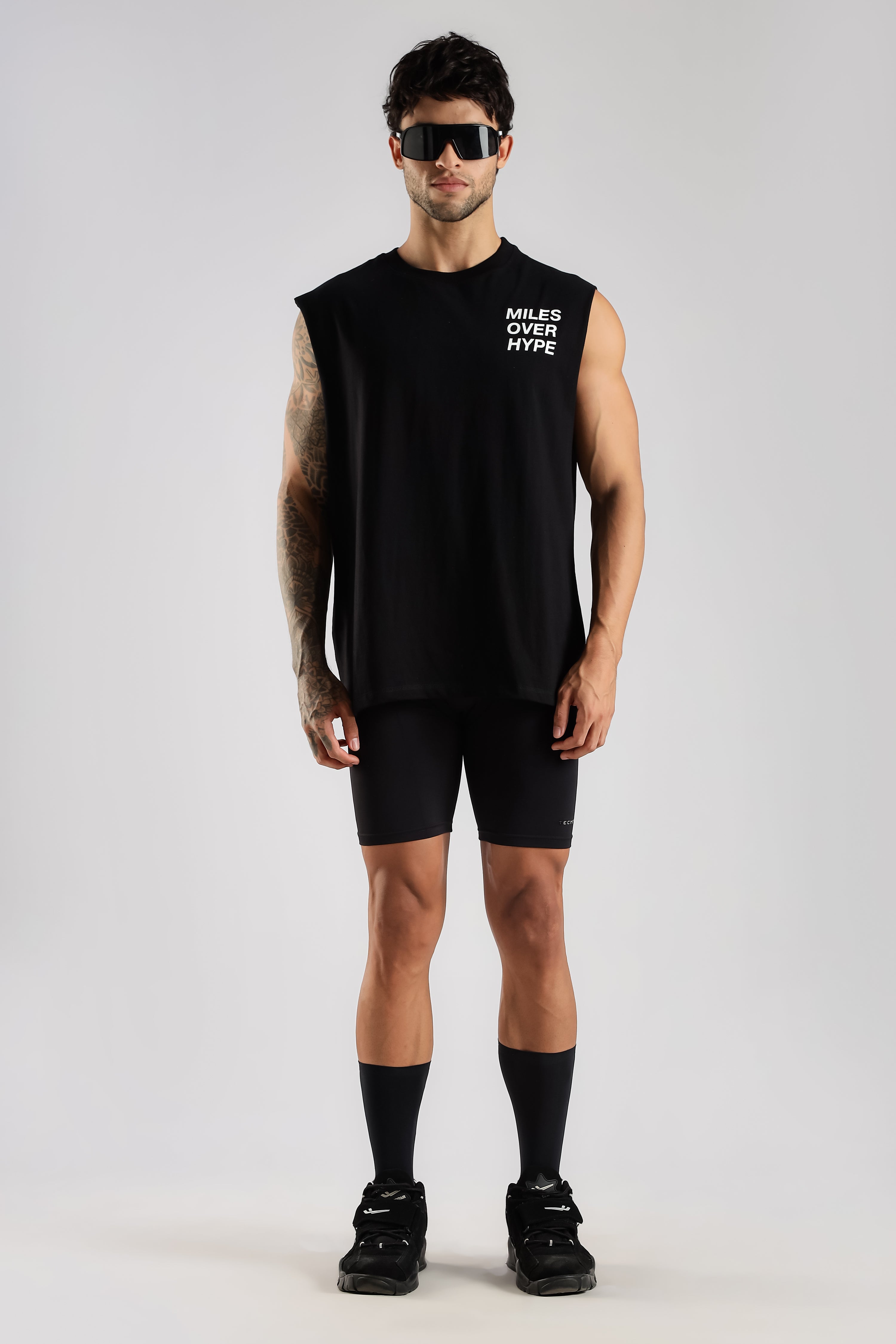 Black men's running tank top, front view, miles over hype graphic