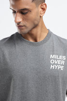Close-up of the Miles Over Hype graphic on the front of the Grey Marl tank top