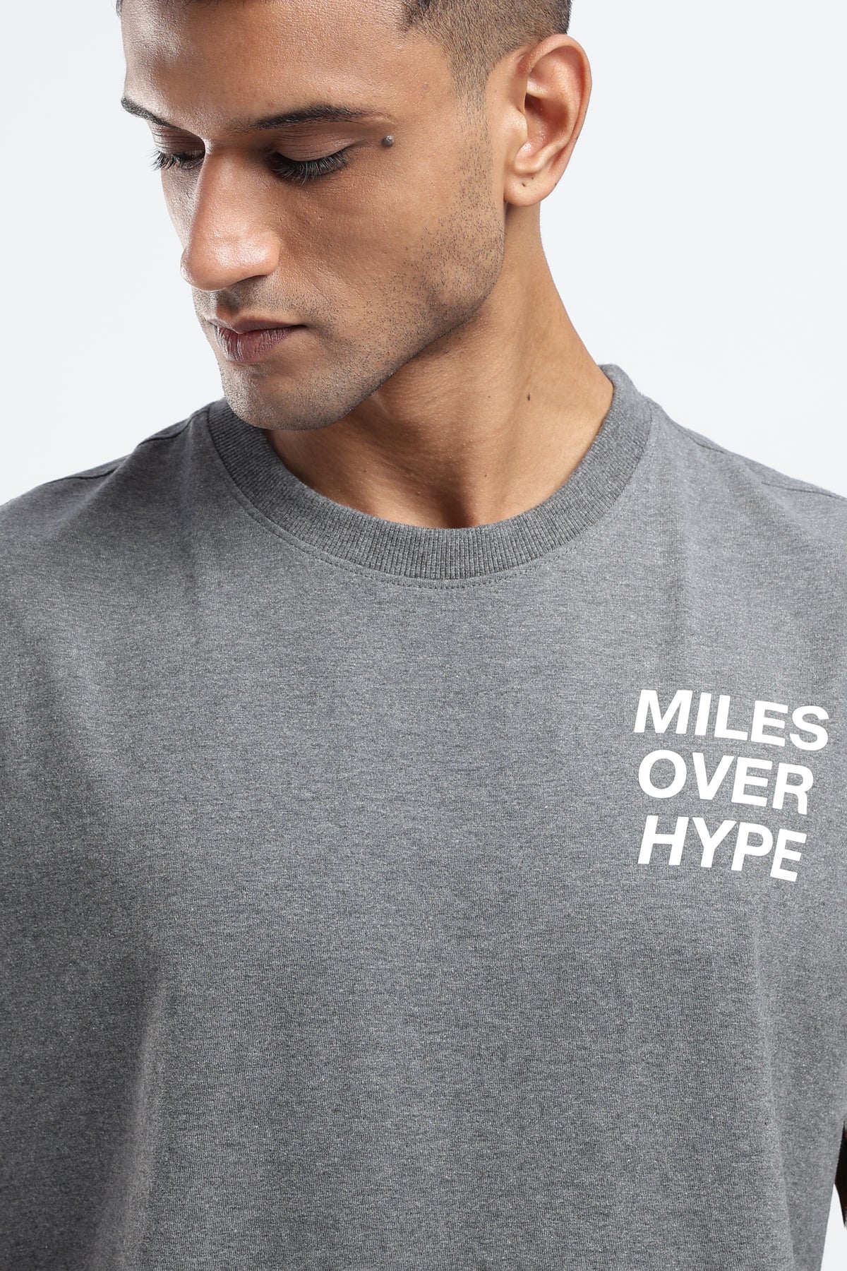 Close-up of the Miles Over Hype graphic on the front of the Grey Marl tank top