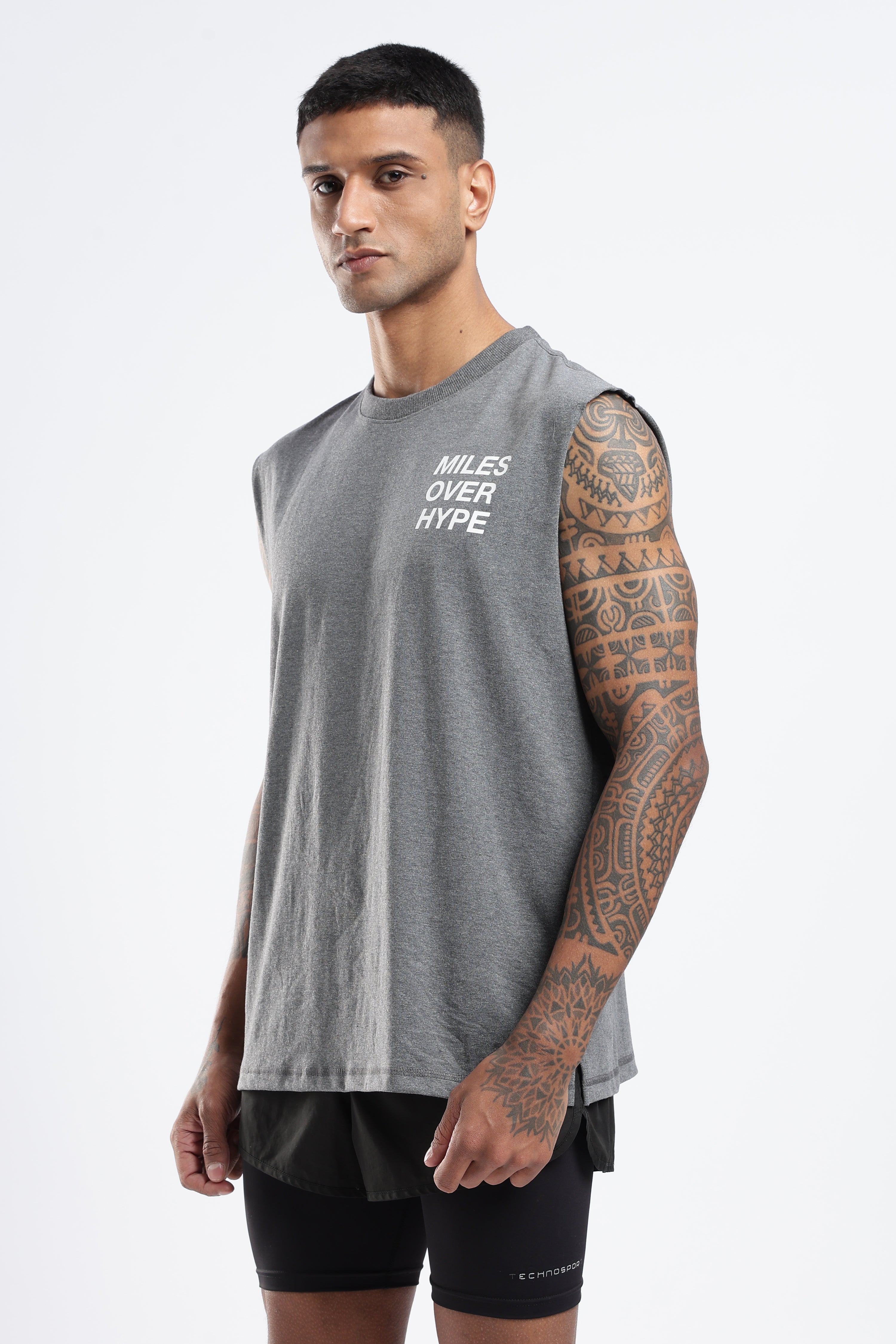 Model wearing the Grey Marl Running Club tank top with Miles Over Hype chest graphic