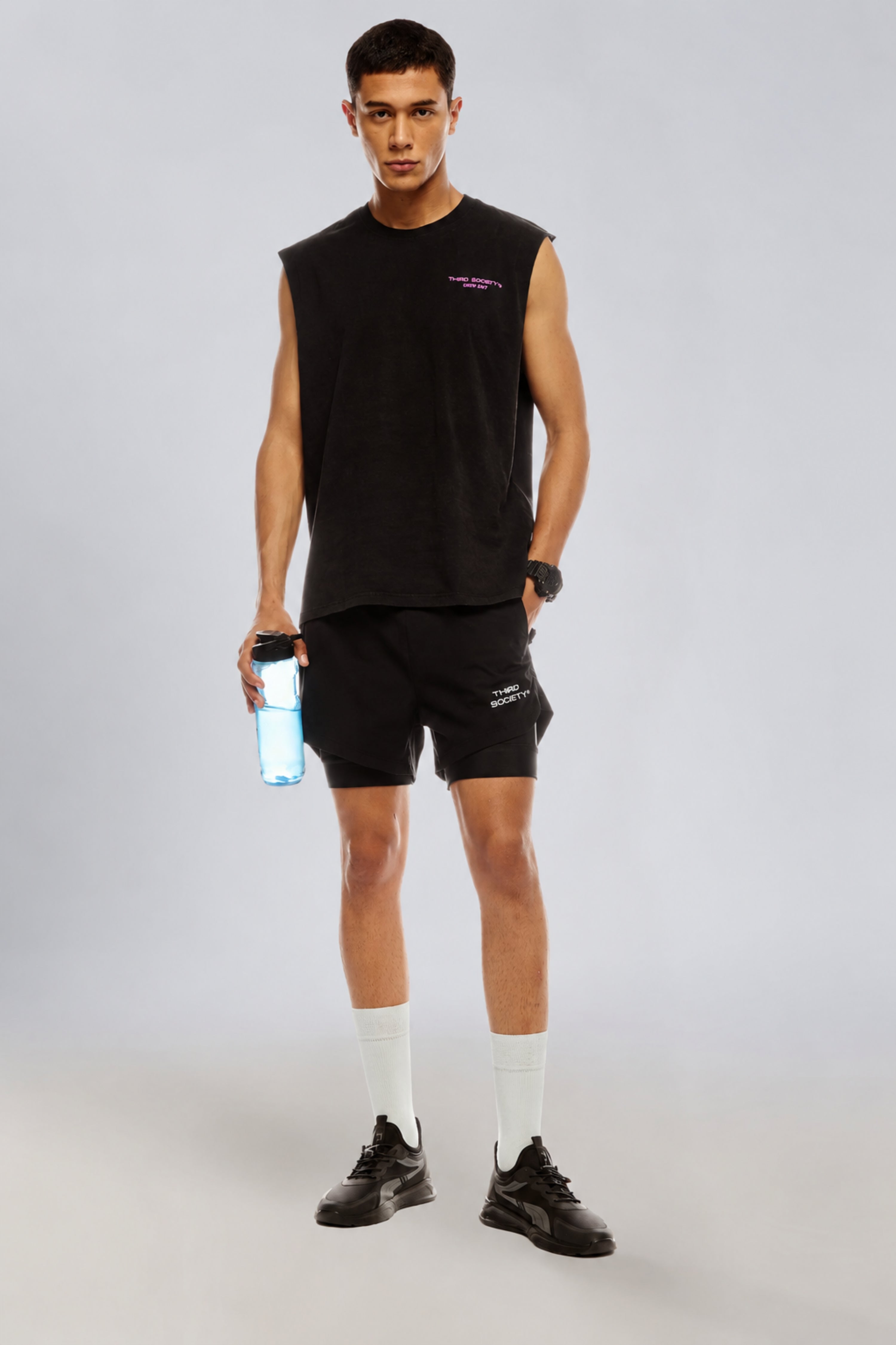 Model wearing the Carbon Wash tank top with black training shorts