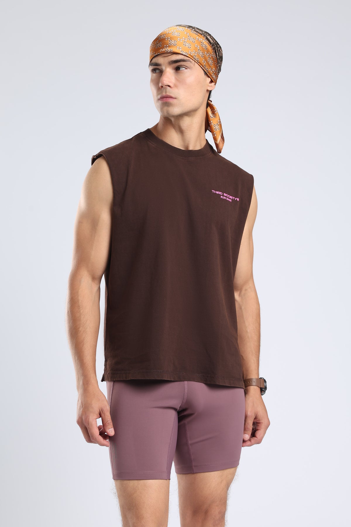 Model wearing the Burnt Umber Wash tank with mauve fitted shorts and black trainers