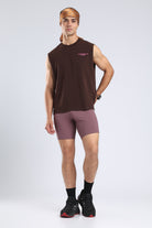Model wearing the Burnt Umber Wash tank with mauve running shorts and a patterned bandana