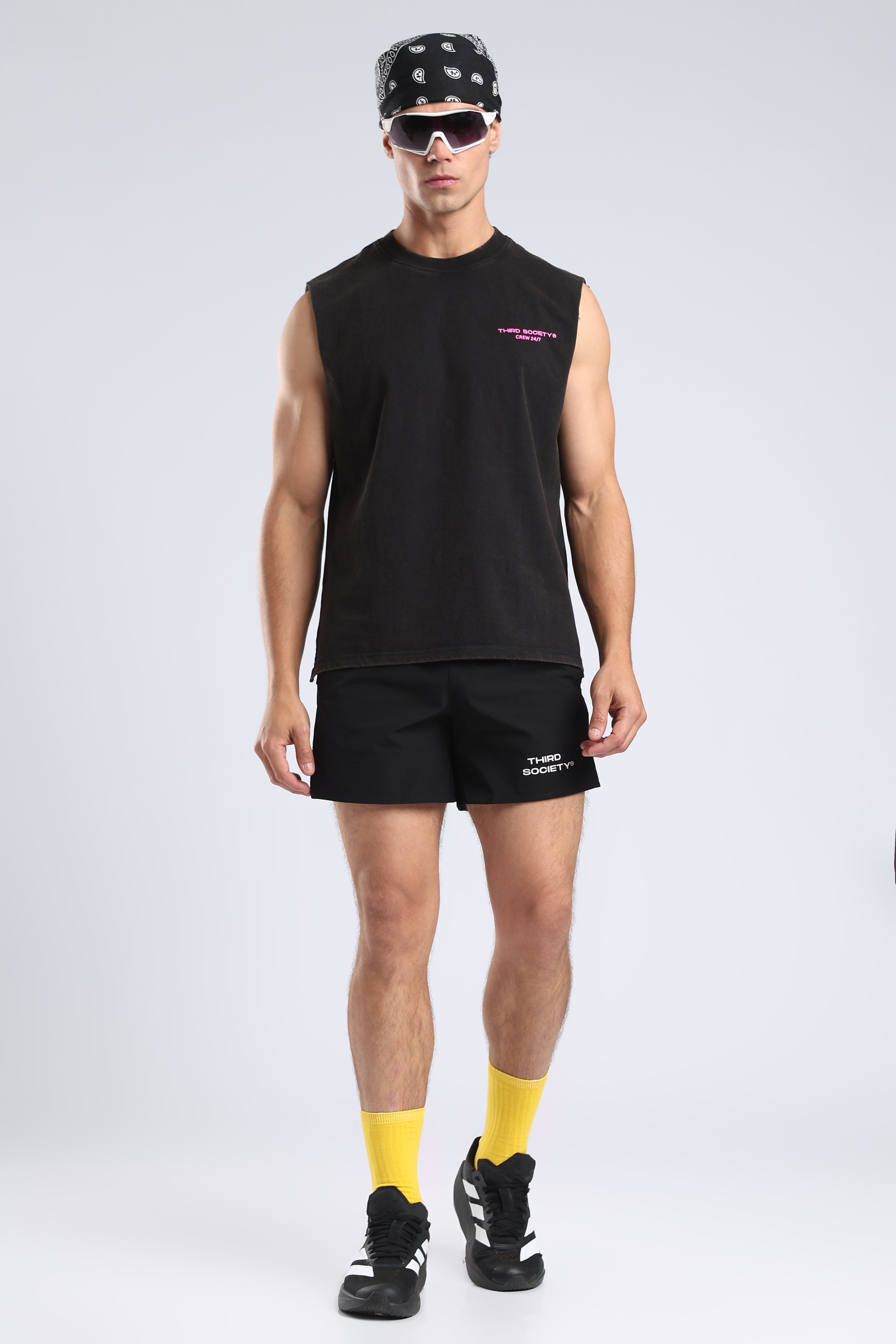 Model wearing the Carbon Wash tank with black shorts and yellow socks
