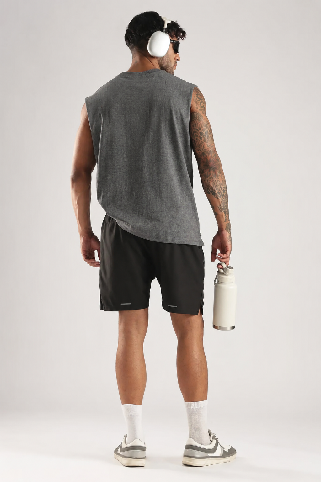Back view of the model wearing the Grey Third Society oversized tank top