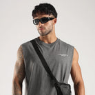 Model wearing the Grey Third Society tank top with Crew 24/7 chest branding