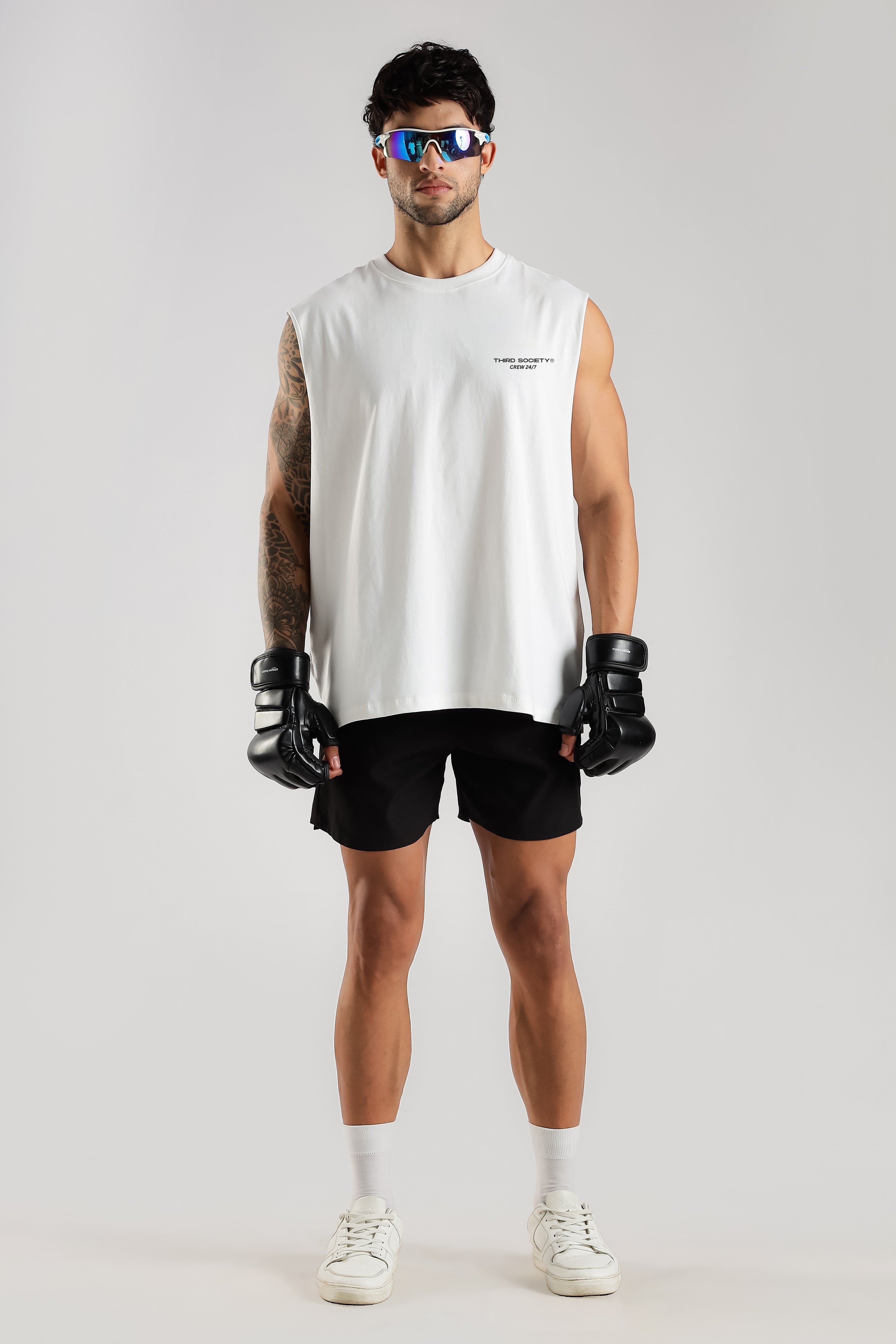 Model wearing the White Third Society tank top with boxing gloves and black training shorts