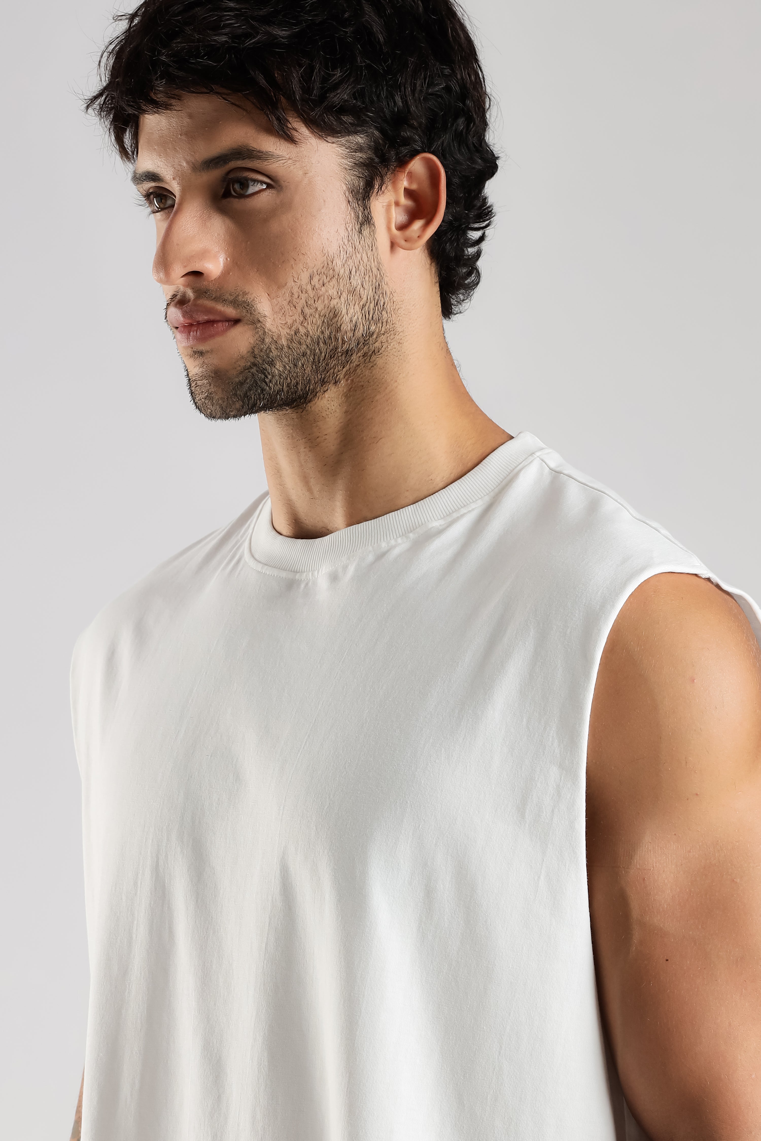 Model wearing the white Training Club tank top with a relaxed fit