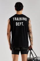 Model wearing the black Training Dept tank top showing the large Training Dept back graphic