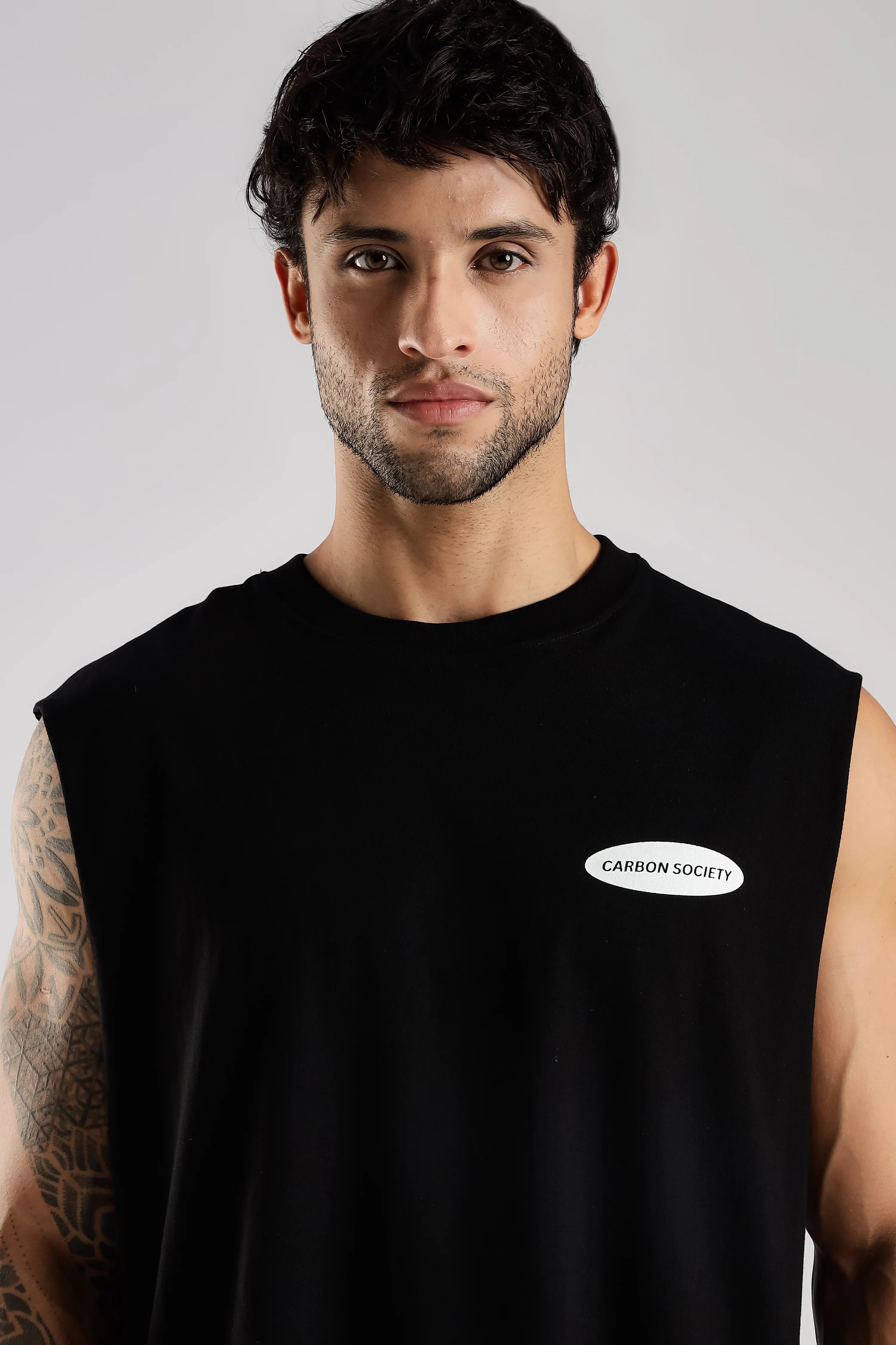 Close-up of the black Training Dept tank top showing the Carbon Society chest logo